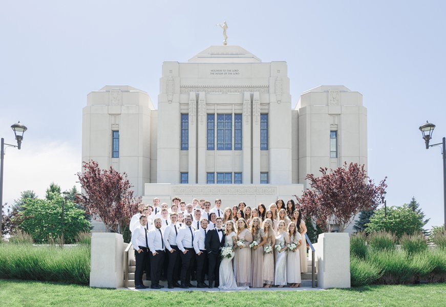  Bride and groom standing with their wedding party in front of an LDS temple after their wedding ceremony. #tonygrove #cachevalley #utahbride #ldstemplewedding #savannarichardsonphotography #utahweddingphotographer #summerwedding #outdoorreception 