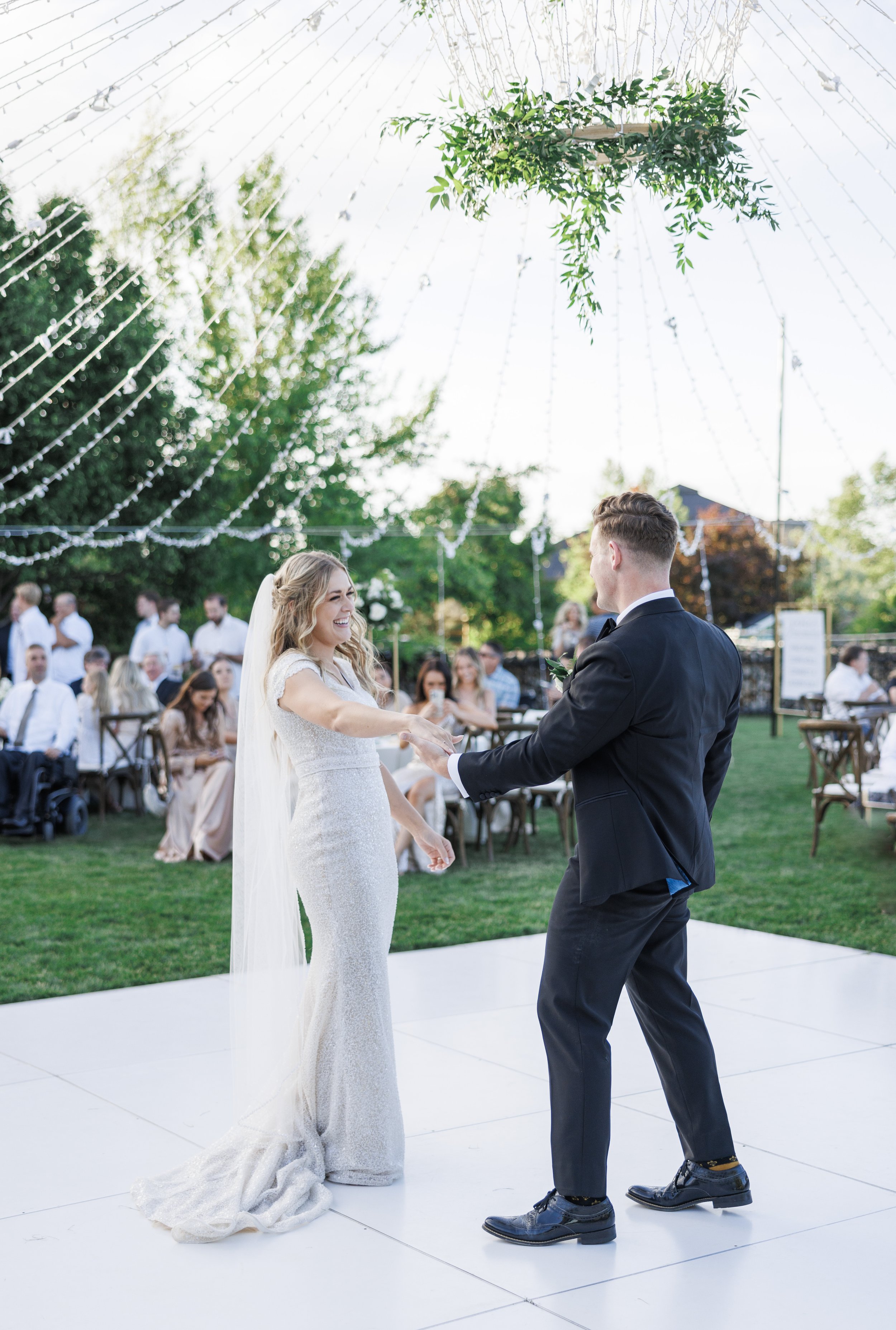  Bride and groom meeting in the middle of the dance floor at their outdoor summer wedding reception for their first dance as husband and wife. #savannarichardsonphotography #summerwedding #husbandandwife #firstdance #weddingdressinspo #groomhairstyle