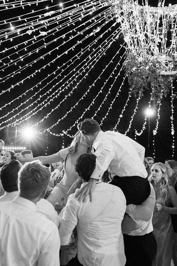  Groomsmen holding the bride and groom up on their shoulders for a kiss on the dance floor at their outdoor wedding reception in Tony Grove. #savannarichardsonphotography #weddingdancing #brideandgroom #funbridalpartyposeideas #cachevalley #tonygrove