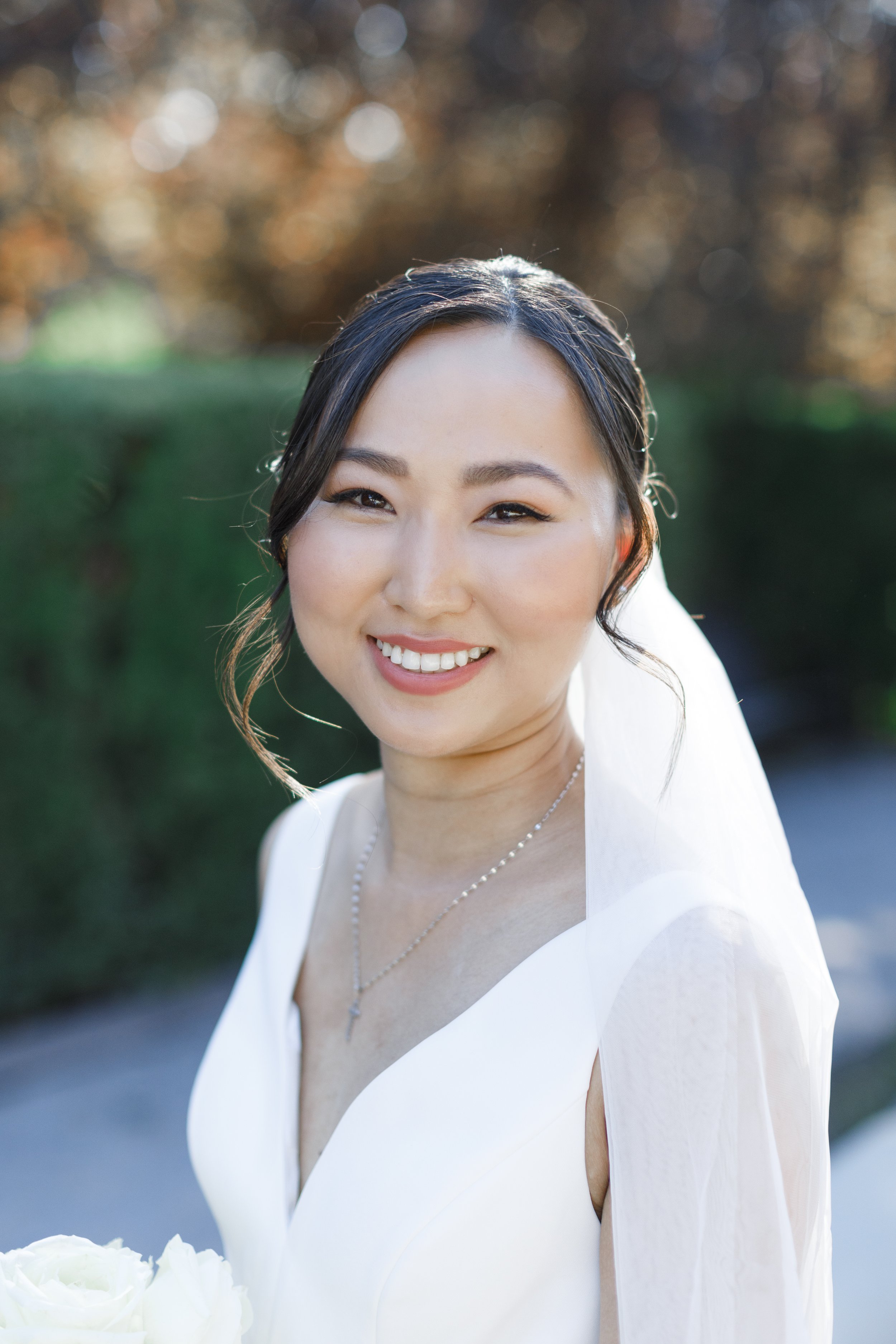  Brunette bride with a sleek bridal updo wearing a cathedral veil and a classy sleeveless wedding dress. #savannarichardsonphotography #thanksgivingpoint #utahweddingphotographer #groomfashion #formalposeinspo #weddingdress #summerwedding #bridemakeu