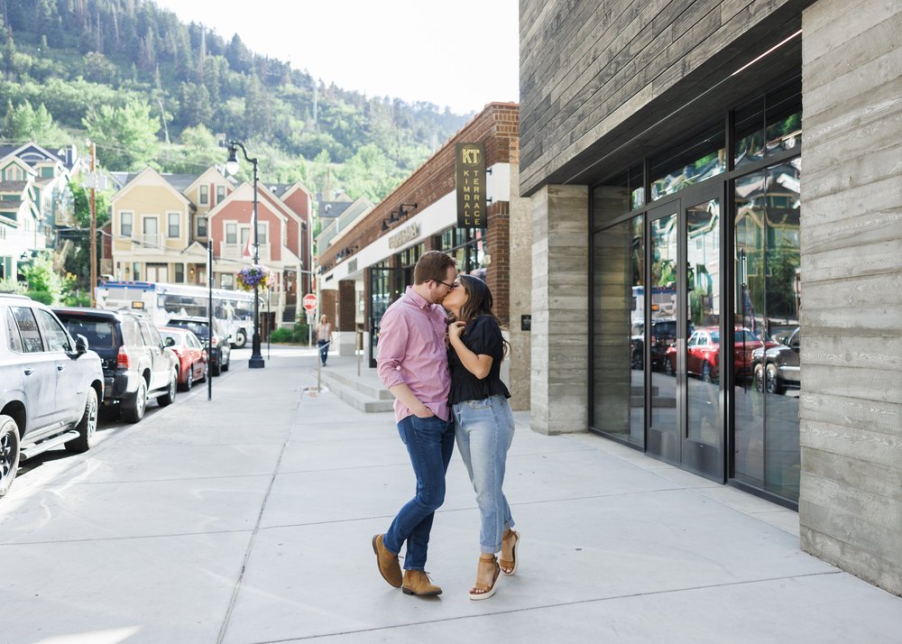  Engaged couple kisses on Park City streets captured by Savanna Richardson Photography. Summer Utah engagement #ParkCityEngagements #ParkCityPhotographers #SavannaRichardsonPhotography #SavannaRichardsonEngagements 
