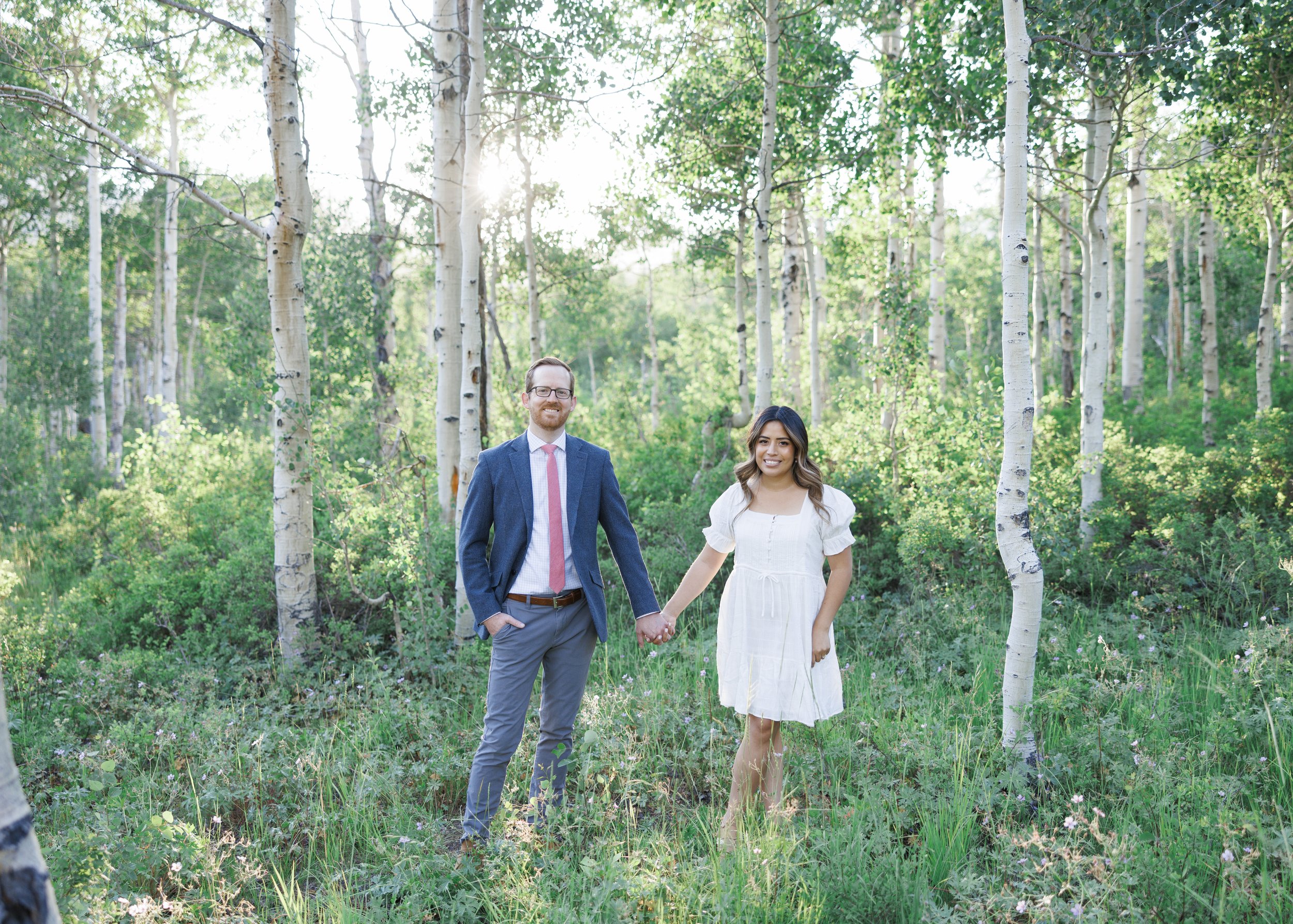  Savanna Richardson Photography captures an engaged couple holding hands in an aspen forest. Mountain engagement ideas #ParkCityEngagements #ParkCityPhotographers #SavannaRichardsonPhotography #SavannaRichardsonEngagements 