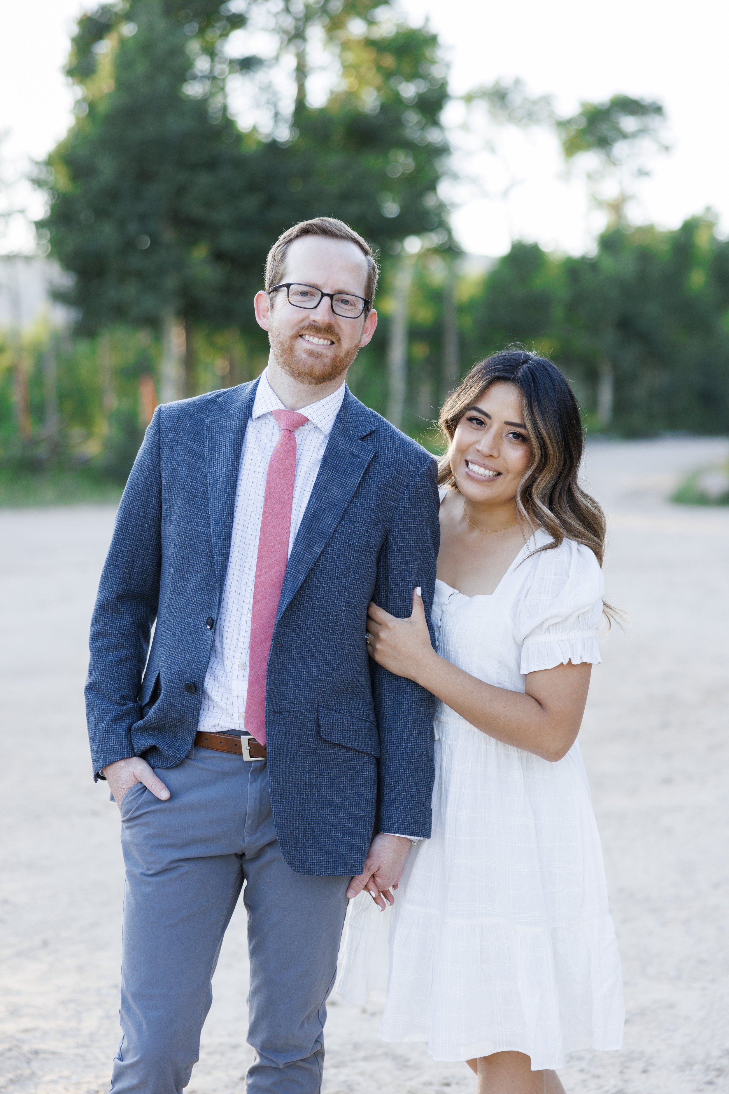  A man smiles while his soon-to-be bride smiles next to him captured by Savanna Richardson Photography. bright and airy engagements #ParkCityEngagements #ParkCityPhotographers #SavannaRichardsonPhotography #SavannaRichardsonEngagements 