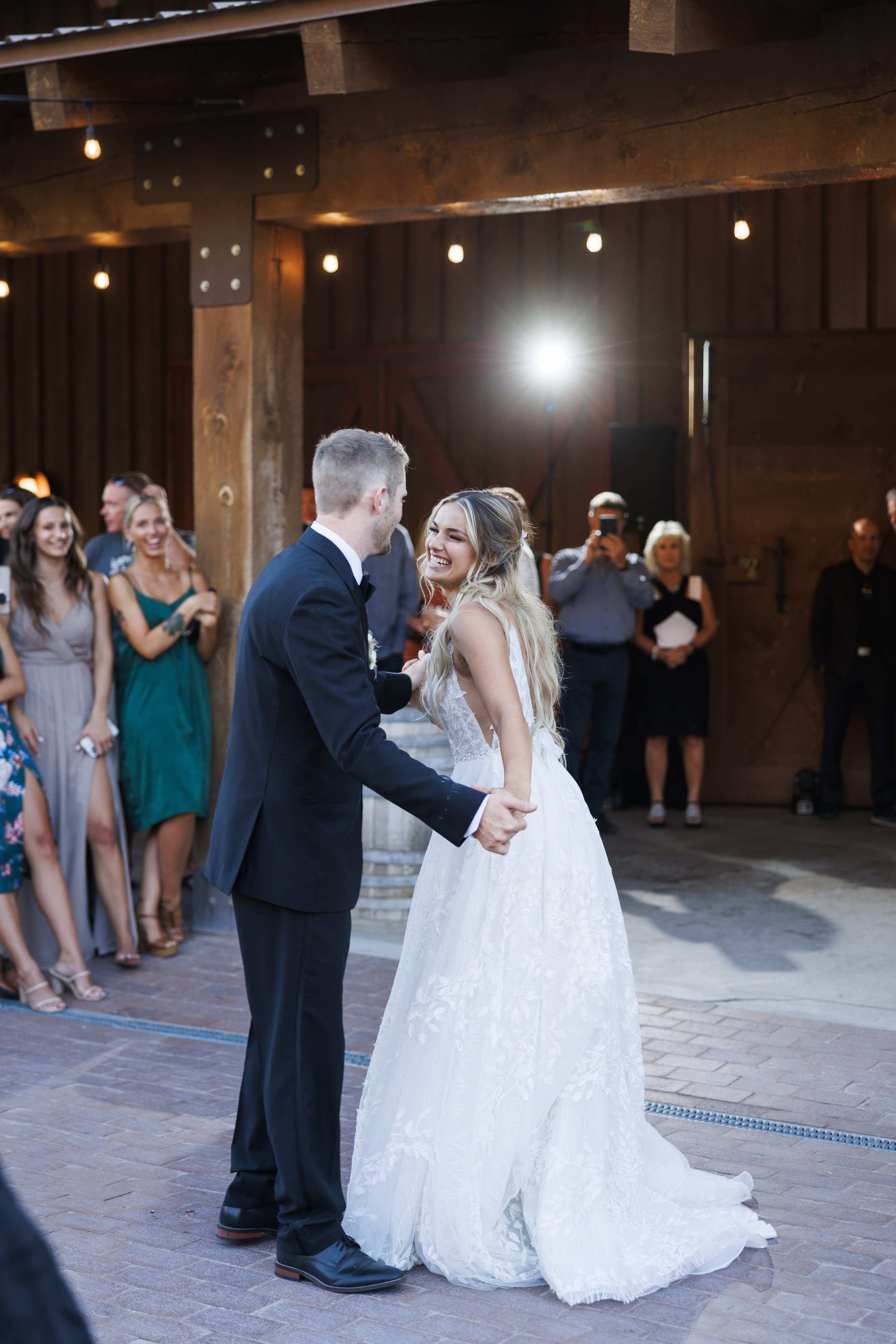  During a small-town wedding in Utah, Savanna Richardson Photography captures the newlyweds dancing in a barn. barn wedding venues Utah #SavannaRichardsonPhotography #SavannaRichardsonWeddings #QuietMeadowFarms #MapletonUTweddingphotographers 