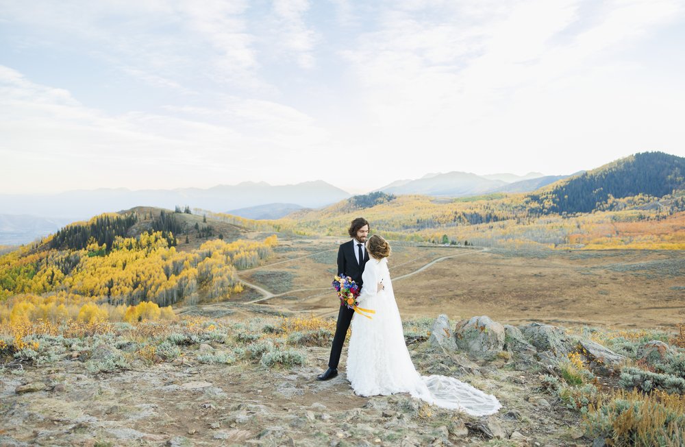  Bride and groom look at one another with the Salt Lake Mountain Range captured by Savanna Richardson Photography. fall bridals #SavannaRichardsonPhotography #SavannaRichardsonFormals #CottonwoodCanyon #WeddingFormals #SLCWedding #fallwed 