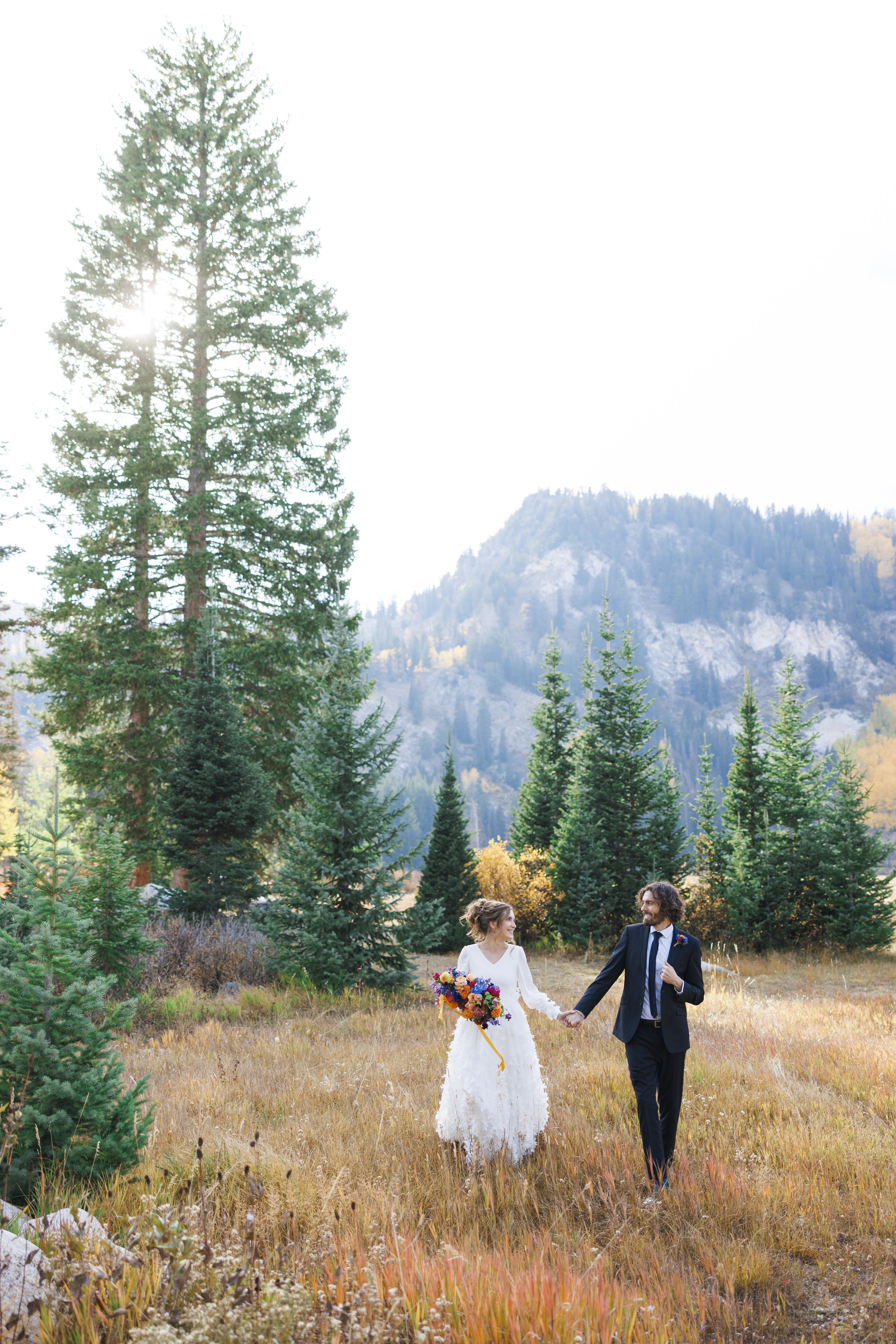  At Silver Lake, a bride and groom hold hands at dusk during a formal session with Savanna Richardson Photography. wedding formals #SavannaRichardsonPhotography #SavannaRichardsonFormals #CottonwoodCanyon #WeddingFormals #SLCWedding #fallwed 