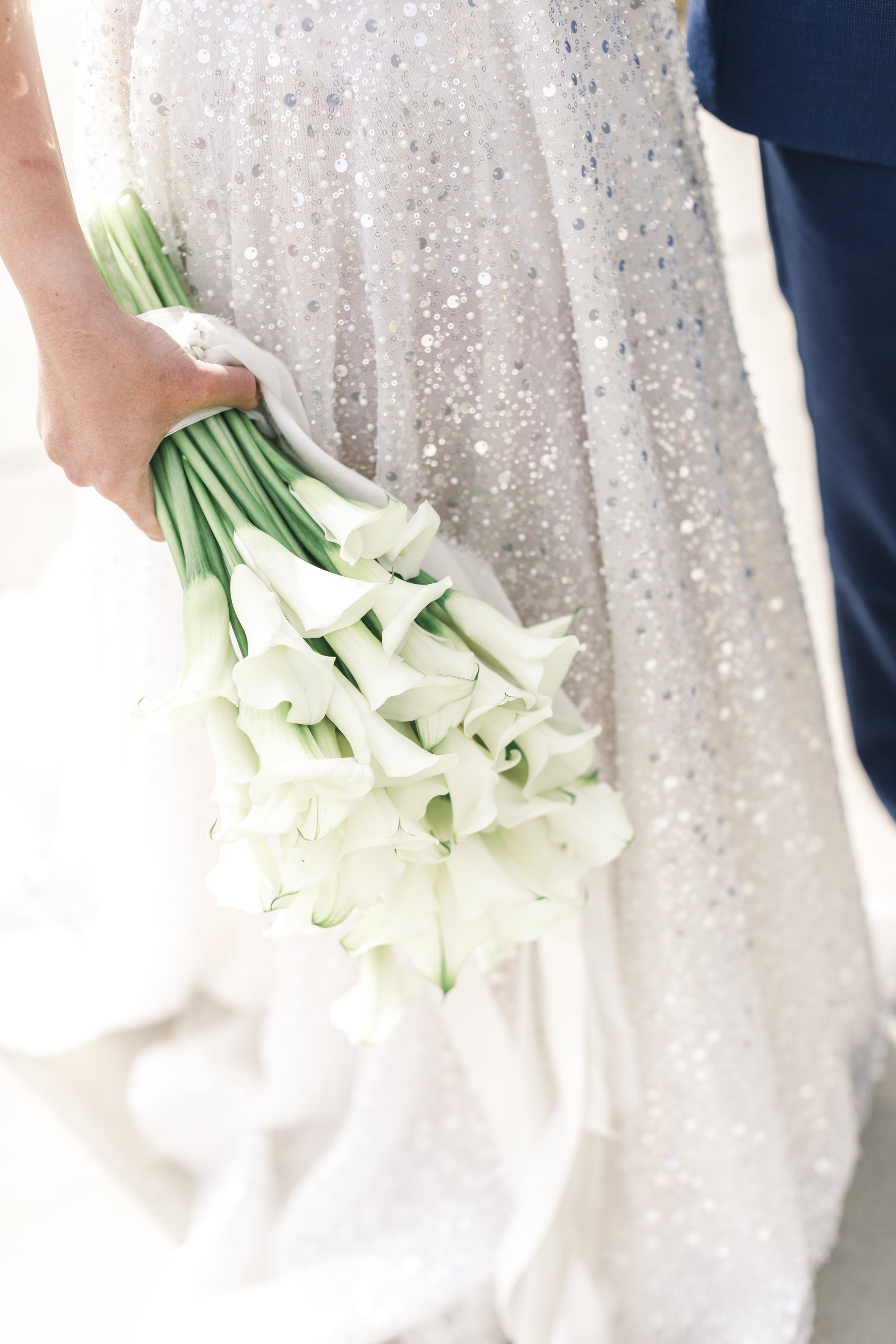  Savanna Richardson Photography captures a bride wearing a sparkly dress and holding a bouquet of lilies. lily bouquet #SavannaRichardsonPhotography #SavannaRichardsonWeddings #bridals #formals #bouquets #Utahweddingphotographers #Wedding 