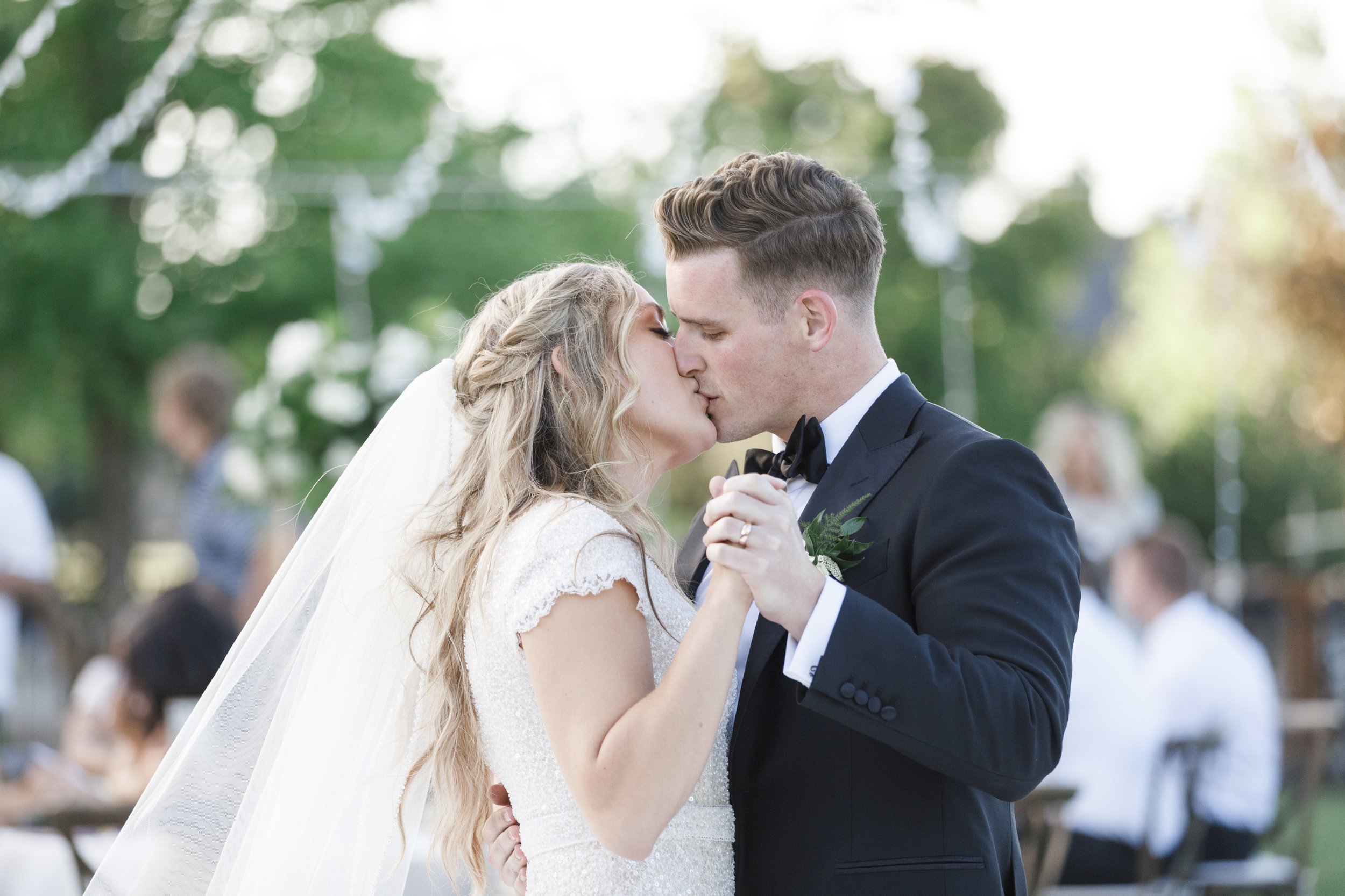  A bride and groom kiss during their first dance at their reception captured by Savanna Richardson Photography. first dance #SavannaRichardsonPhotography #SavannaRichardsonWeddings #bridals #formals #bouquets #Utahweddingphotographers #Wedding 