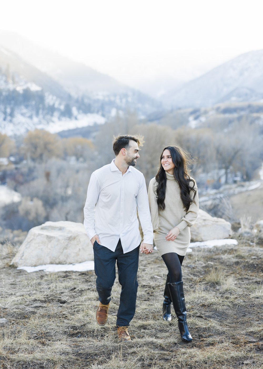  A man and woman walking together on a snowy mountaintop by Savanna Richardson Photography a Utah Professional. Utah proposal photos #SavannaRichardsonPhotography #Proposal #proposalphotography #ProProposalCompany #engaged #engagementphotography 