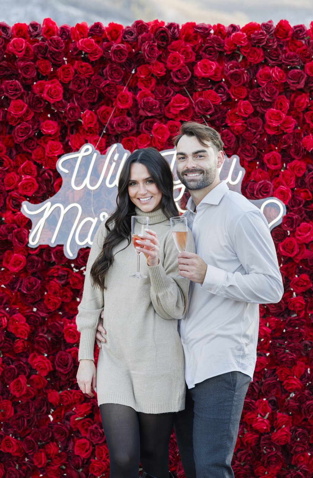  During a proposal a couple chair a drink in front of a floral wall by Savanna Richardson Photography. champagne celebration #SavannaRichardsonPhotography #Proposal #proposalphotography #ProProposalCompany #engaged #engagementphotography 