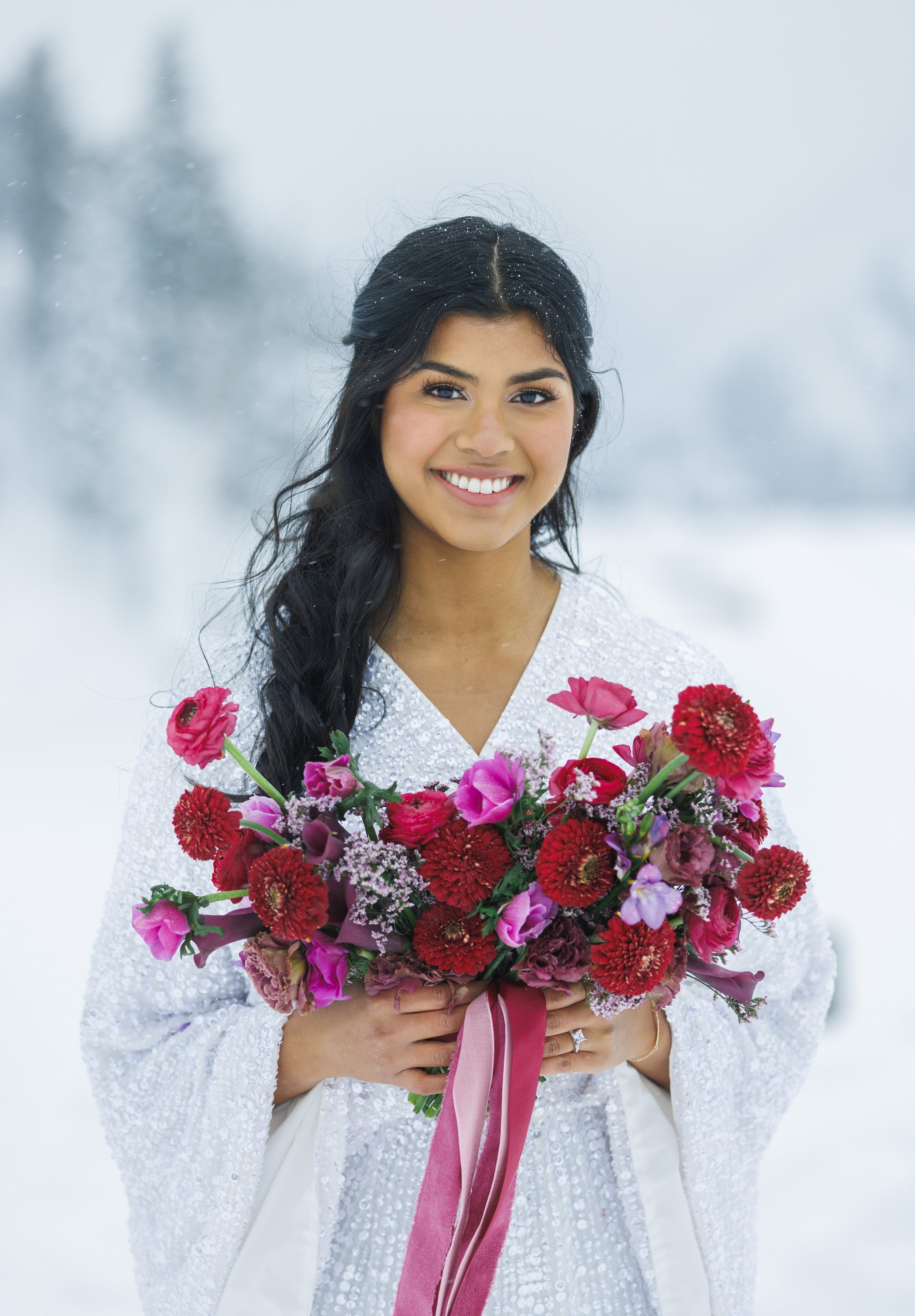  Beautiful snow bride with a pink and red bouquet and glitter gown by Savanna Richardson Photography. winter inspo #SavannaRichardsonPhotography #SavannaRichardsonBridals #WinterBridals #WinterWedding #TibbleForkBridals #UtahBridals #MountainBridals 