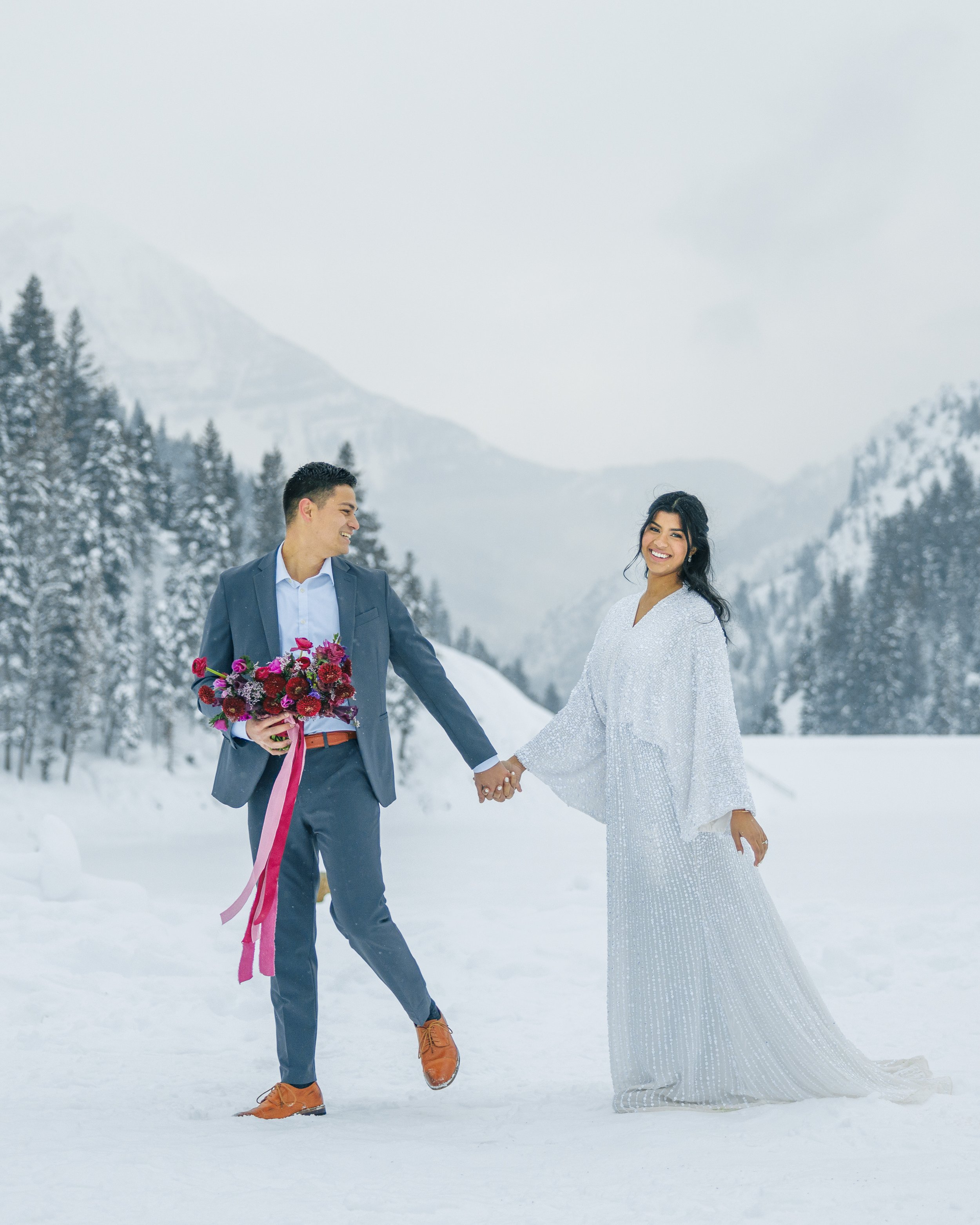  A groom leads his bride along the snowy mountain pass by Savanna Richardson Photography. winter wedding inspiration #SavannaRichardsonPhotography #SavannaRichardsonBridals #WinterBridals #WinterWedding #TibbleForkBridals #UtahBridals #MountainBridal