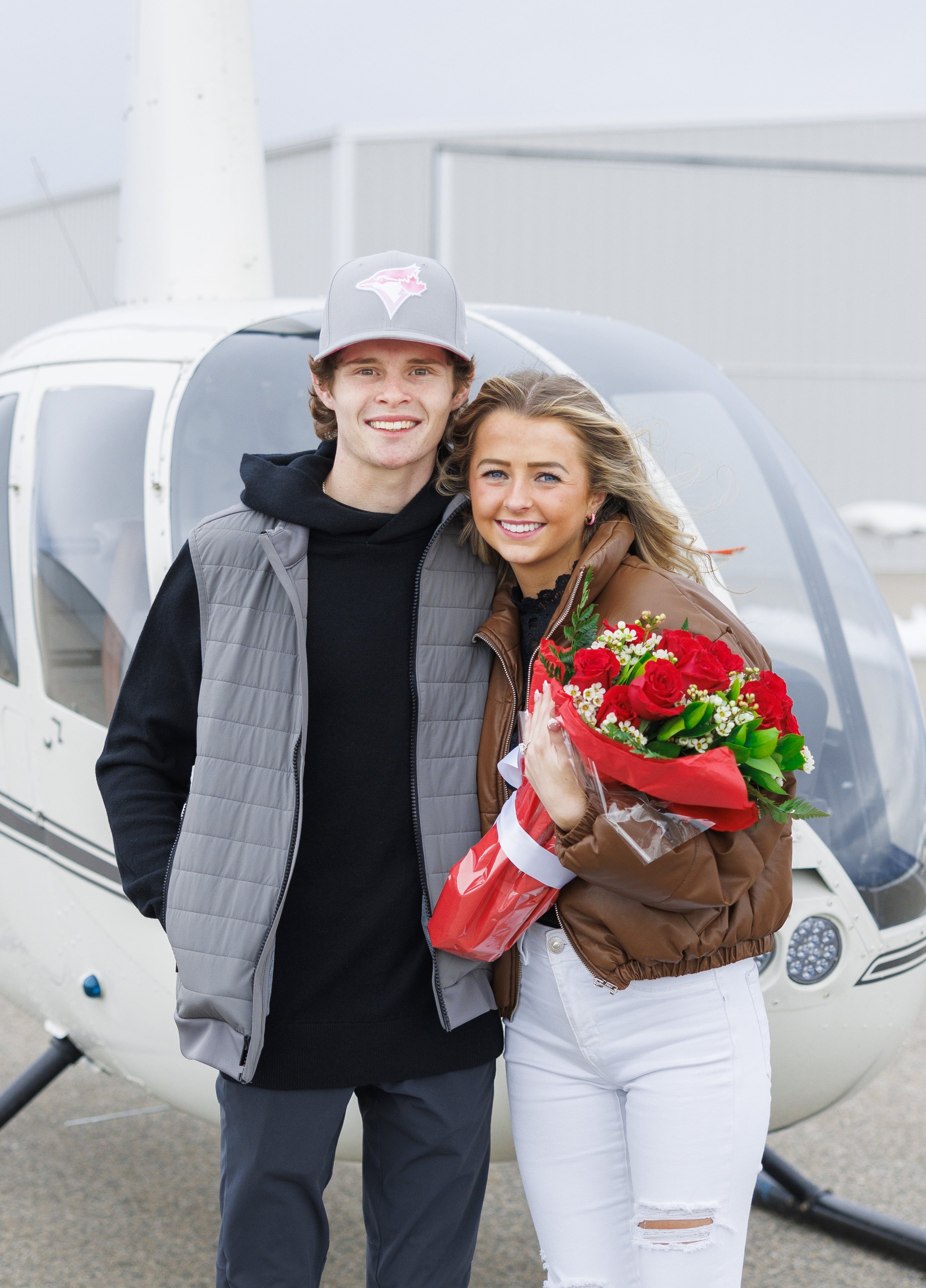  Savanna Richardson Photography captures a happy couple with red roses and a helicopter after the proposal. cute helicopter proposals photographer for the proposal in Utah #SavannaRichardsonPhotography #SavannaRichardsonEngagements #utahproposals #he
