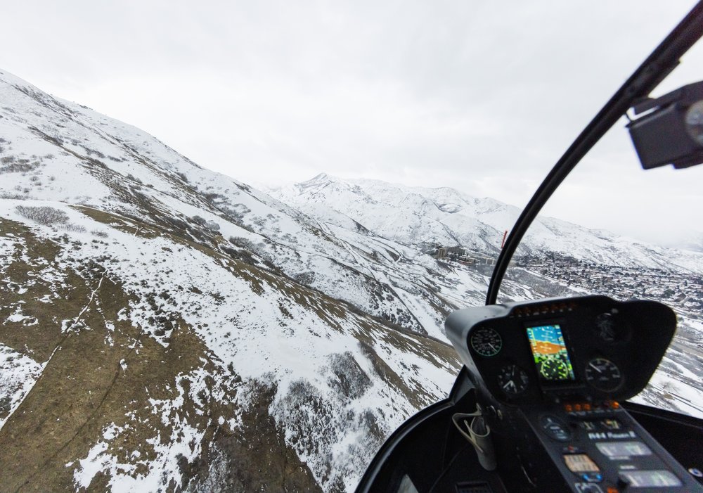  Mountain portrait captured from the front seat of a helicopter during a surprise proposal by Savanna Richardson Photography. Utah Proposal Utah Photographers Mountain engagement #SavannaRichardsonPhotography #SavannaRichardsonEngagements #utahpropos