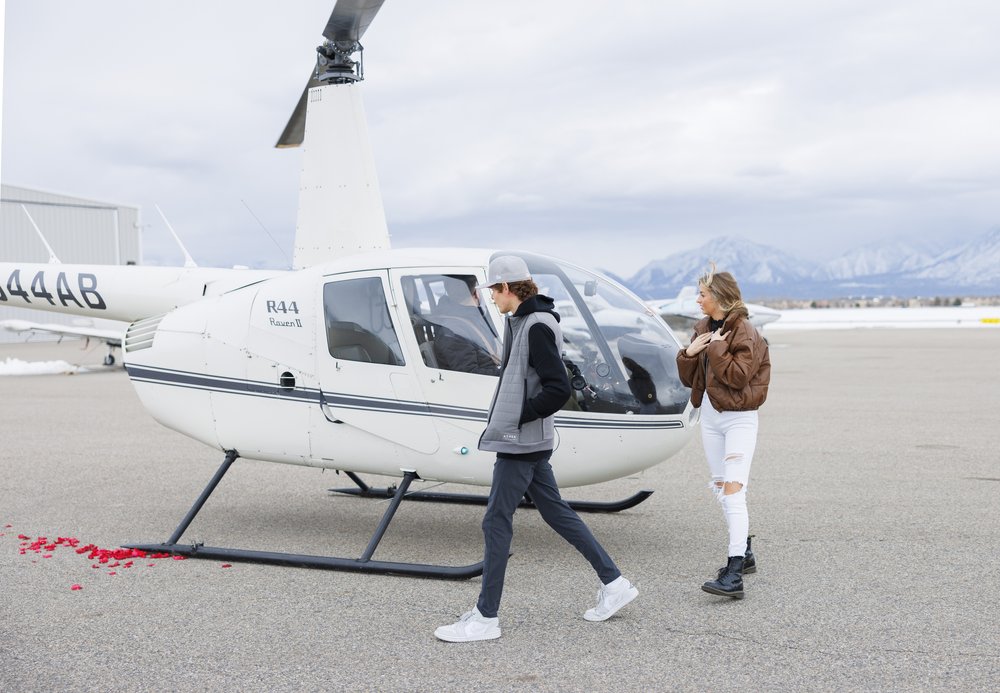  A boyfriend leads his girlfriend to a rose-covered spot for the proposal captured by Savanna Richardson Photography. rose petal proposal proposal details #SavannaRichardsonPhotography #SavannaRichardsonEngagements #utahproposals #helicopterproposal 