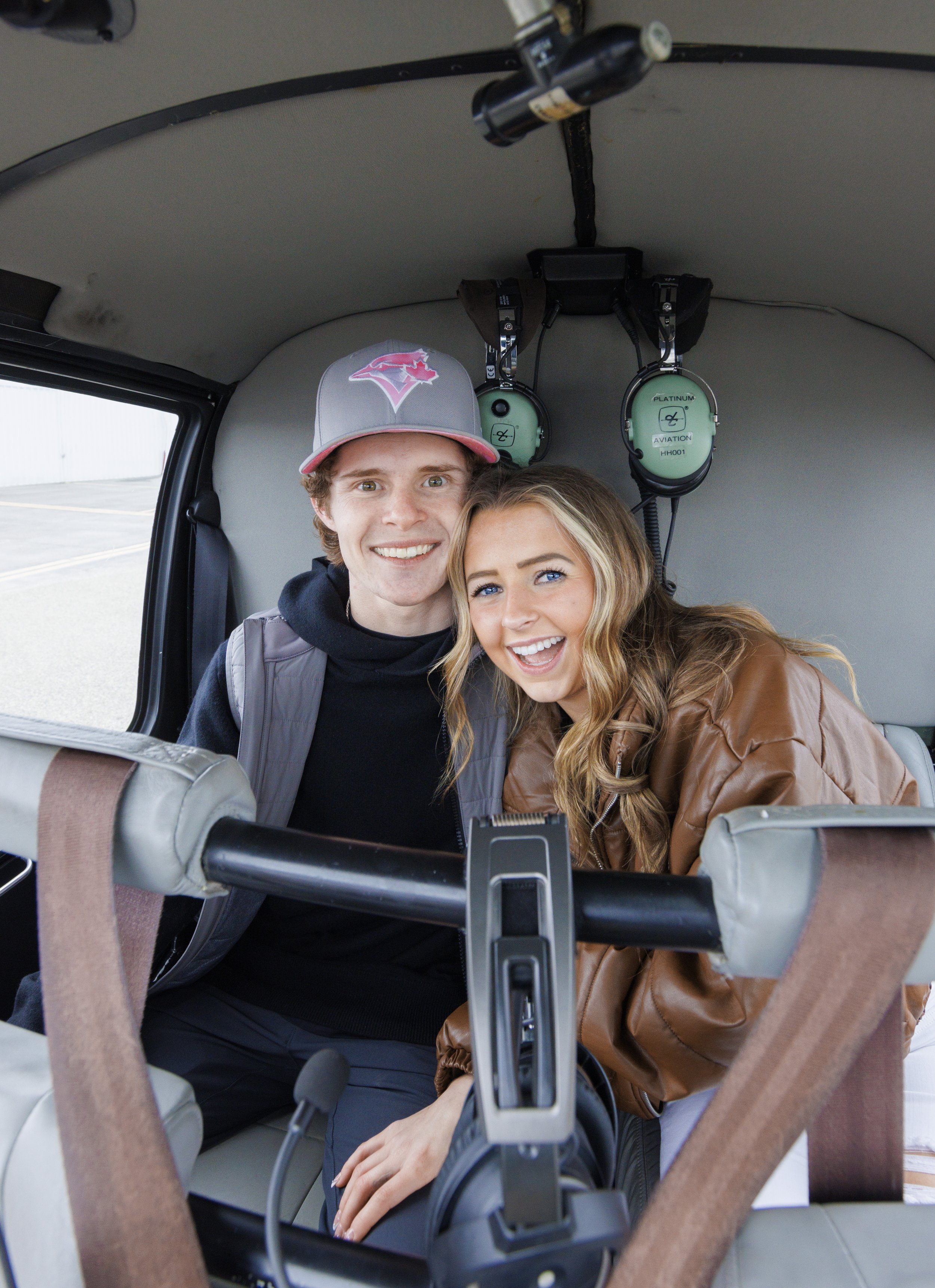  The engagement photographer captures a couple snuggled together in a helicopter by Savanna Richardson Photography. happy couple she said yes proposal photography #SavannaRichardsonPhotography #SavannaRichardsonEngagements #utahproposals #helicopterp