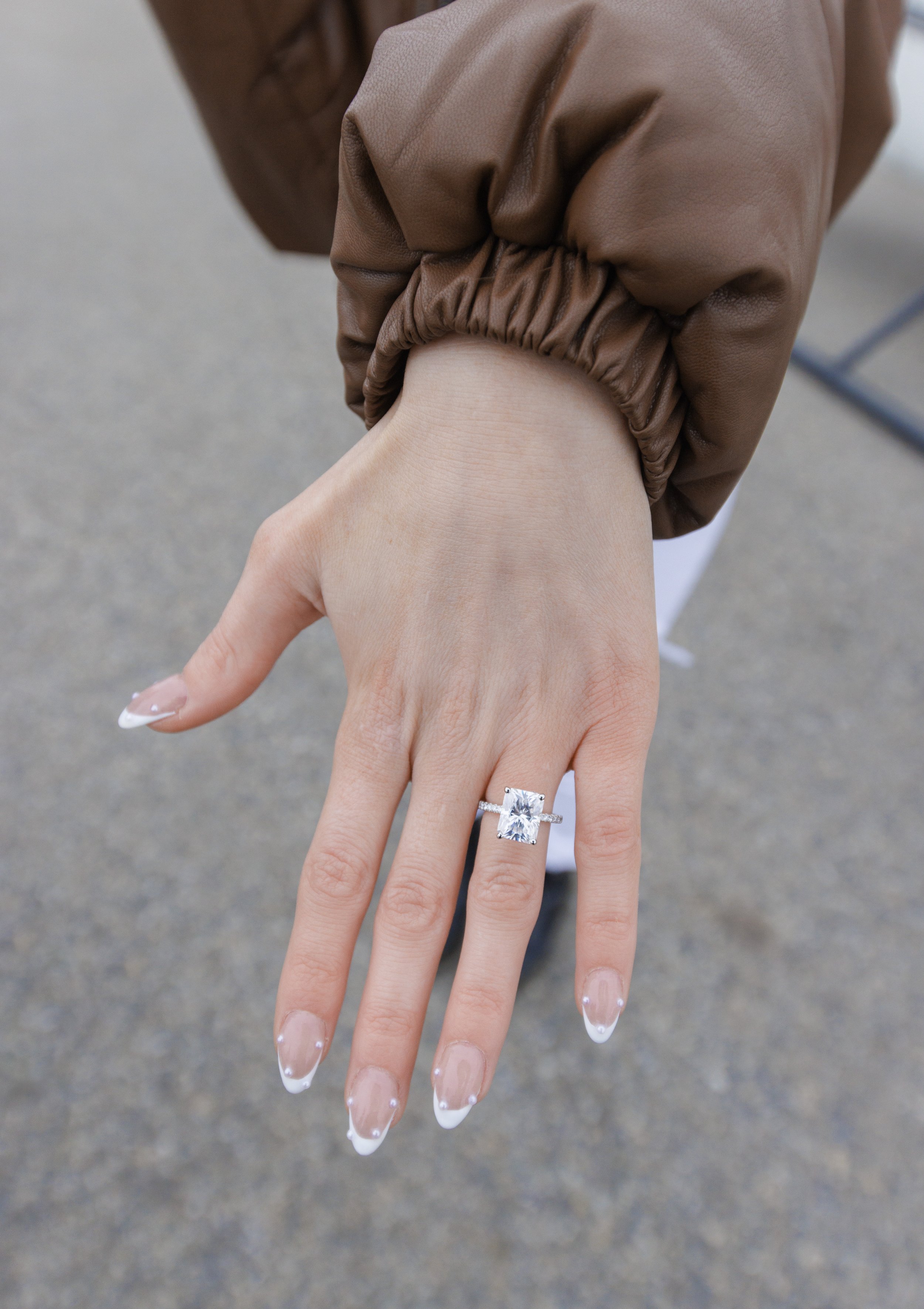  A portrait of the engagement ring on the woman's finger featuring a rectangle diamond by Savanna Richardson Photography. wedding ring simple classic ring #SavannaRichardsonPhotography #SavannaRichardsonEngagements #utahproposals #helicopterproposal 