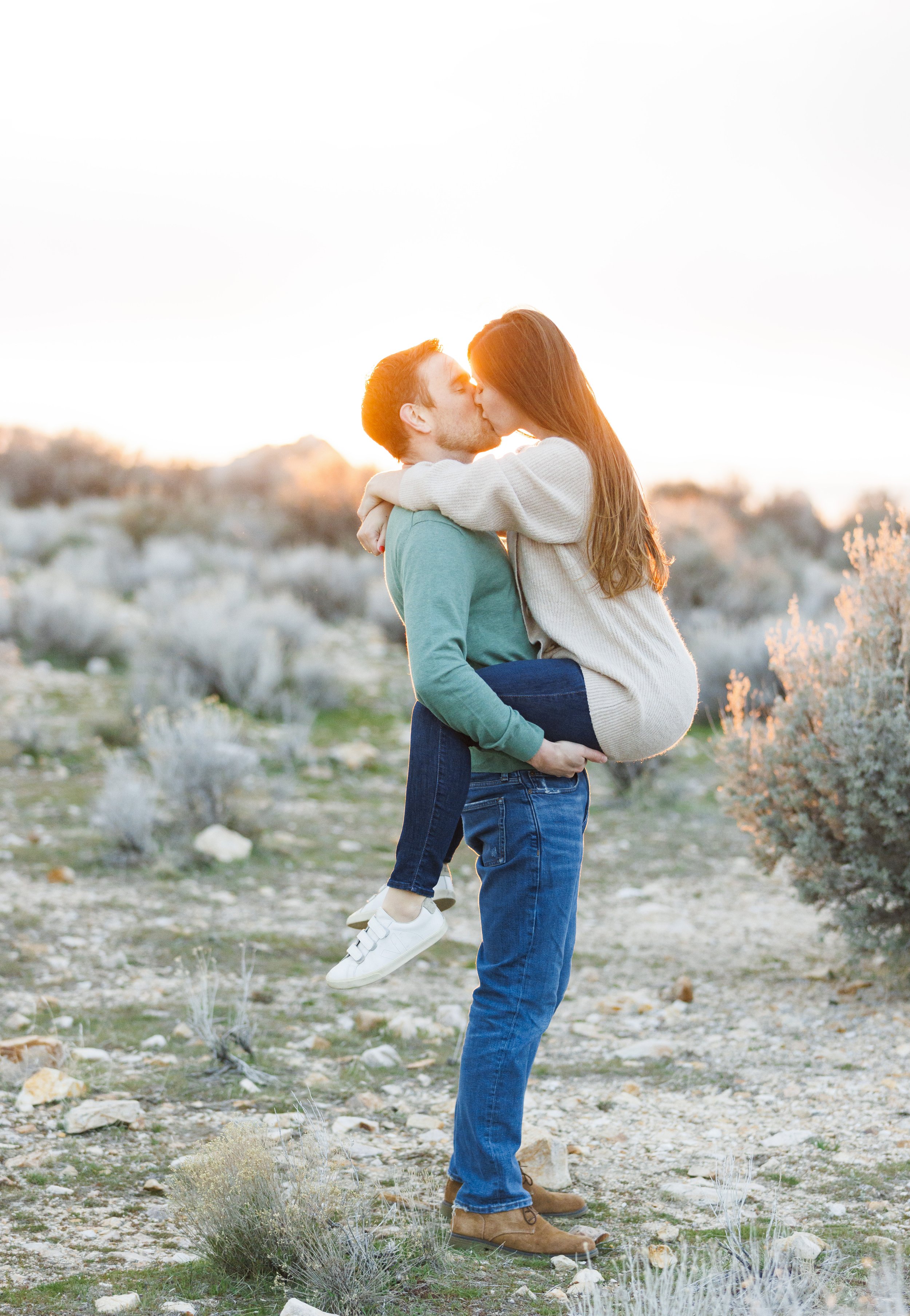  At sunset on Antelope Island, a woman jumps up into her fiance's arms and kisses him by Savanna Richardson Photography. romantic engagement photos sunset kisses #SavannaRichardsonPhotography #SavannaRichardsonEngagements #UtahEngagements #AntelopeIs