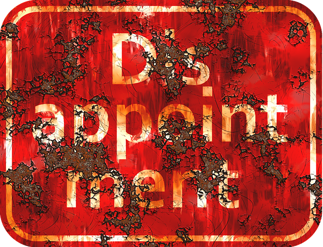 A rusty sign that has the words Disappointment