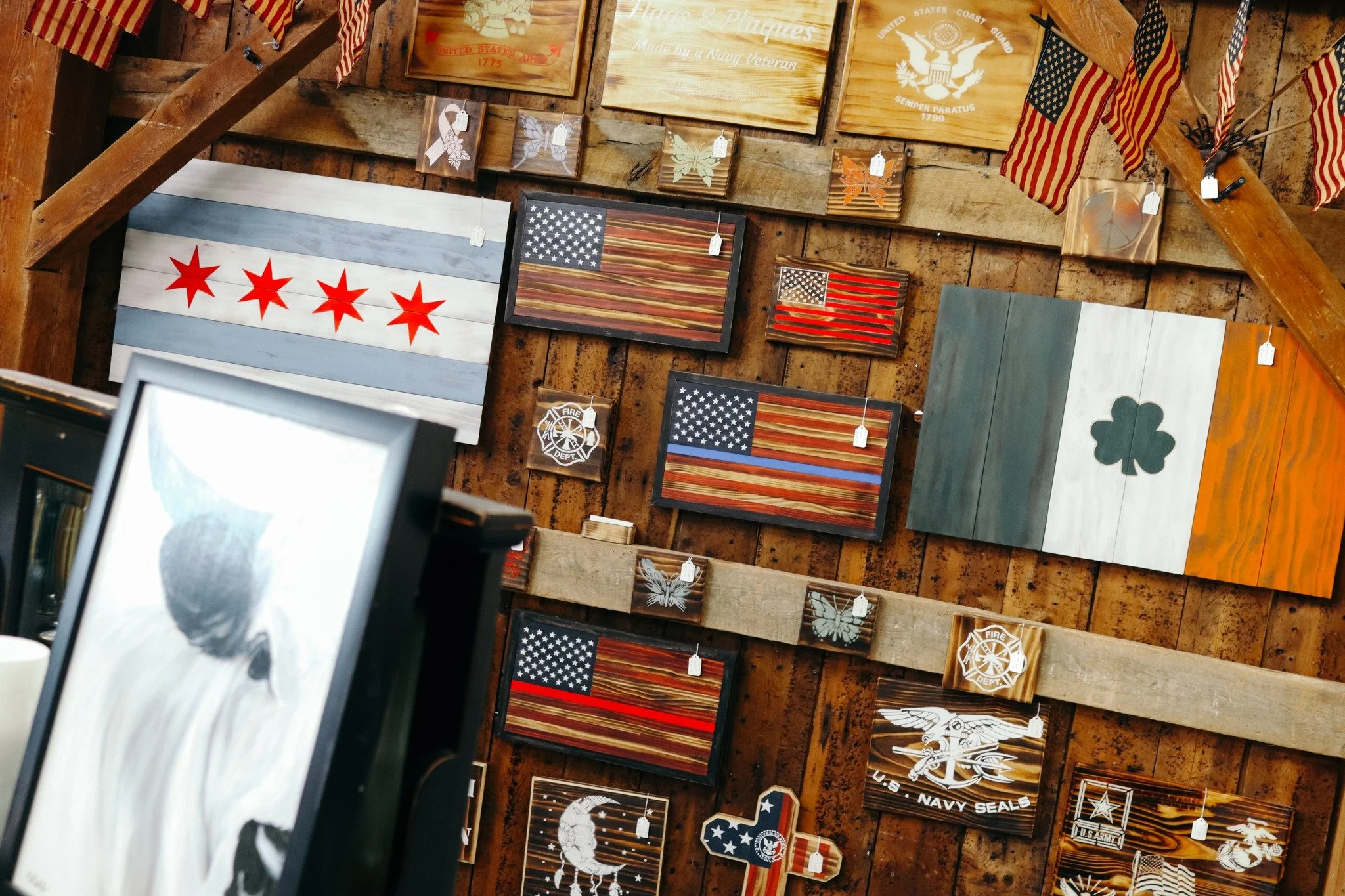 A GREAT GIFT IDEA!

Have you seen the unique, rustic flags and plaques featured upstairs at the barn? We offer a wide variety of patriotic, first responder, and military pieces that would be a great gift for someone in your life. Stop in and see them