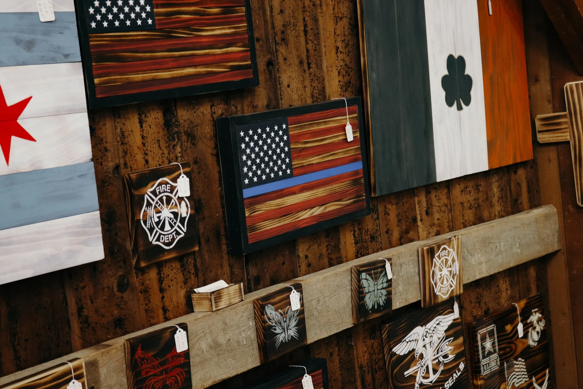 A GREAT GIFT IDEA!

Have you seen the unique, rustic flags and plaques featured upstairs at the barn? We offer a wide variety of patriotic, first responder, and military pieces that would be a great gift for someone in your life. Stop in and see them