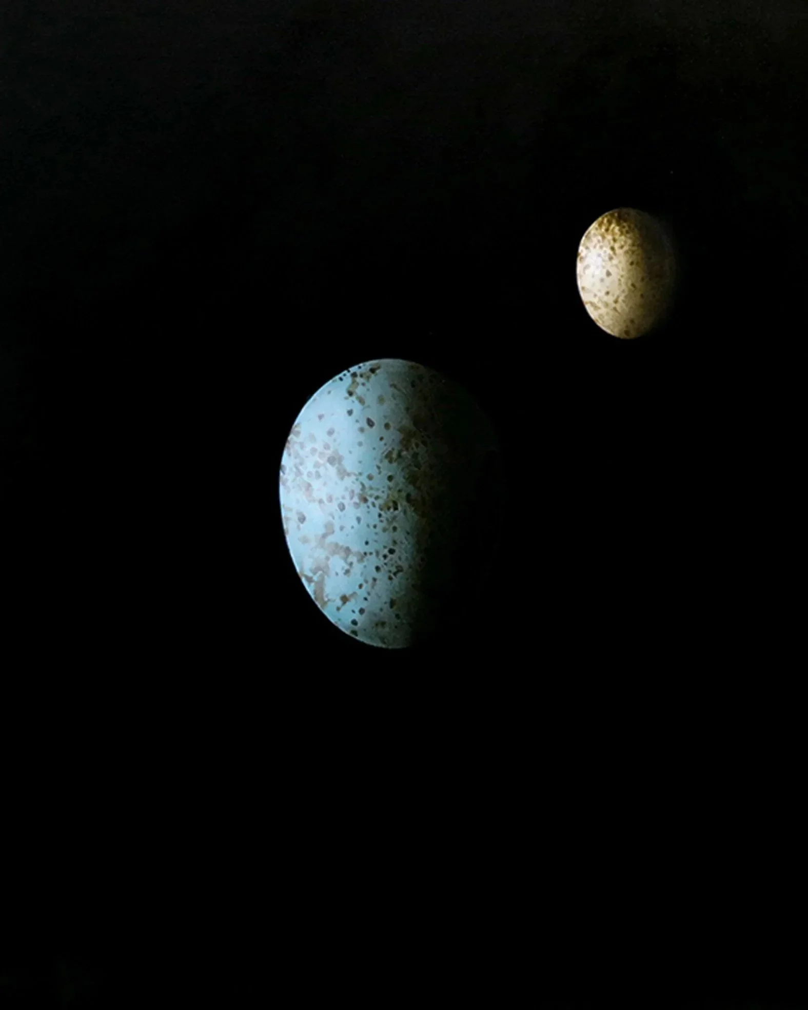 Surreal still life of two eggs representing the fragile Earth and Moon by Mike Skidmore.