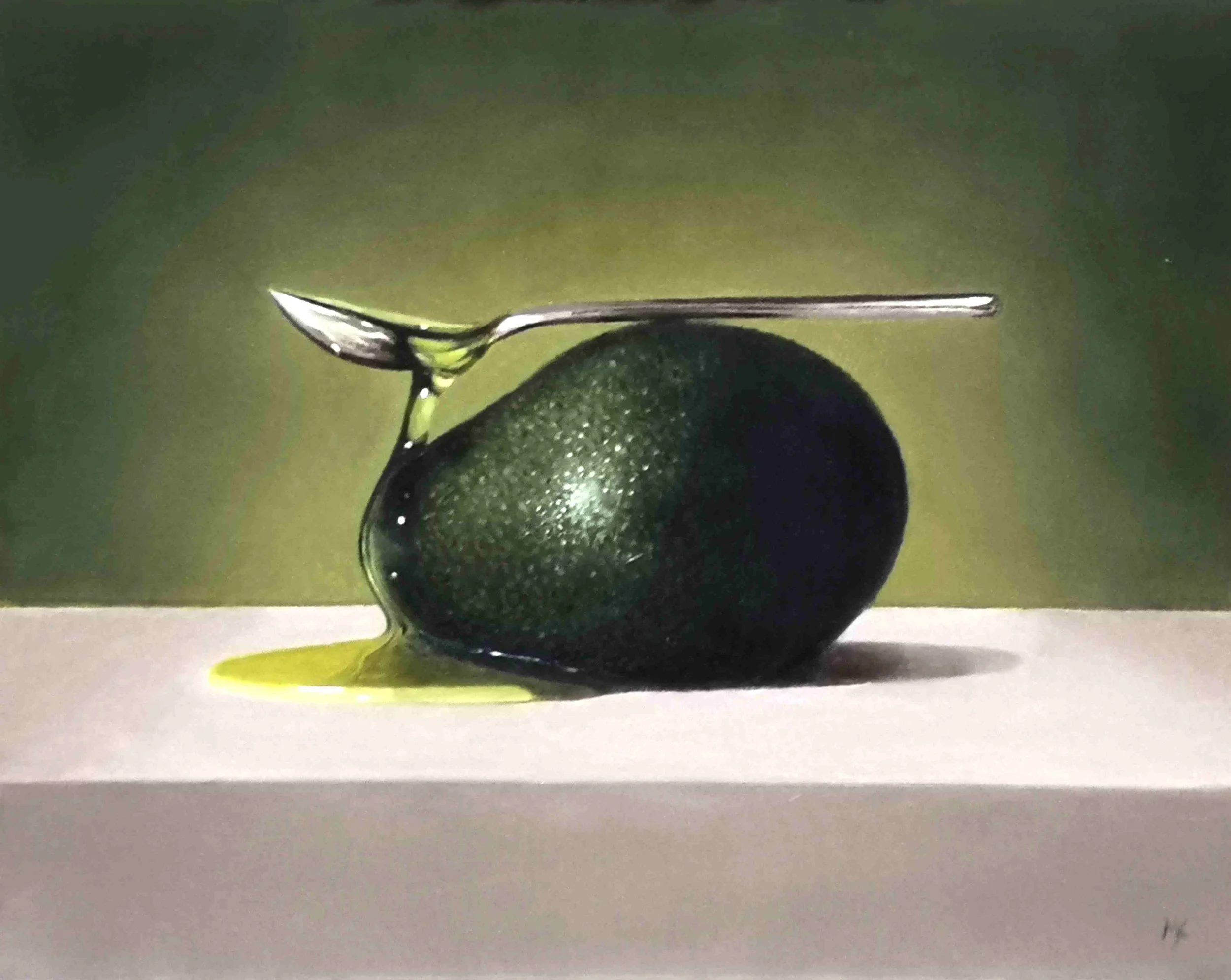 Still life art with a spoon impossibly balanced on an avocado.