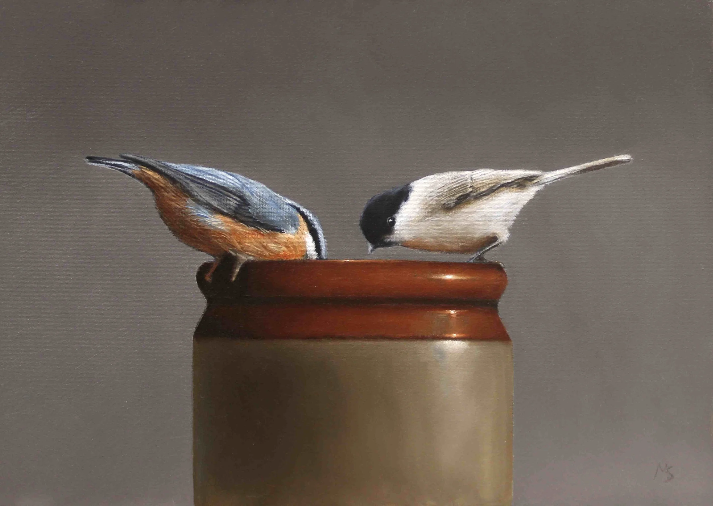 Still life of a nuthatch and black cap garden birds searching for seeds in a pot.