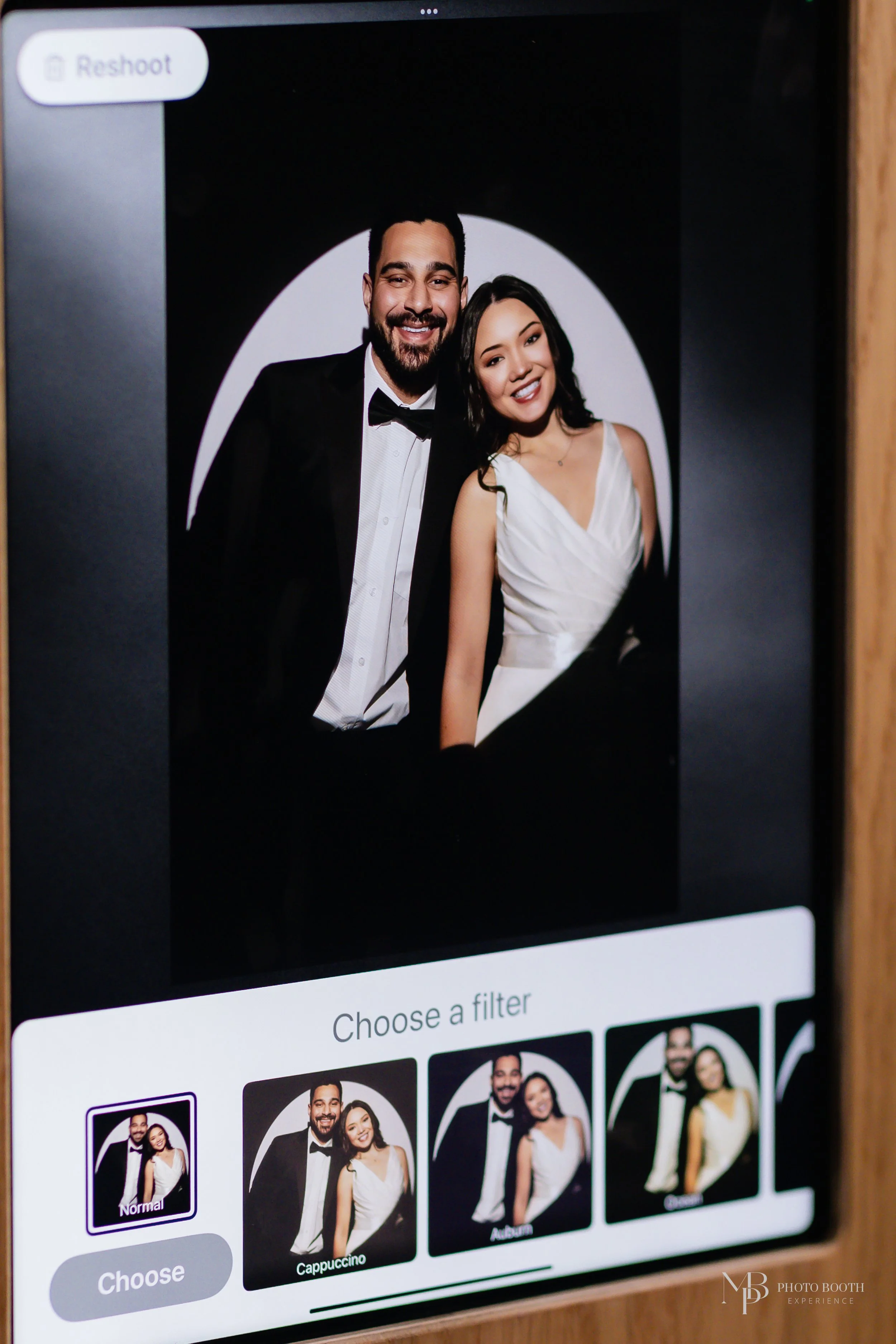 Couple posing for a dramatic spotlight portrait using a studio-style spotlight photo booth with interactive filters and editorial-inspired event photography.