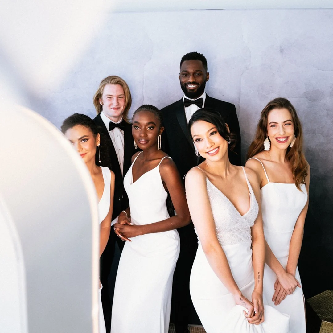 Guests posing for elegant glam booth portraits during a luxury wedding event with studio-quality lighting and editorial-style black and white photo booth photography.