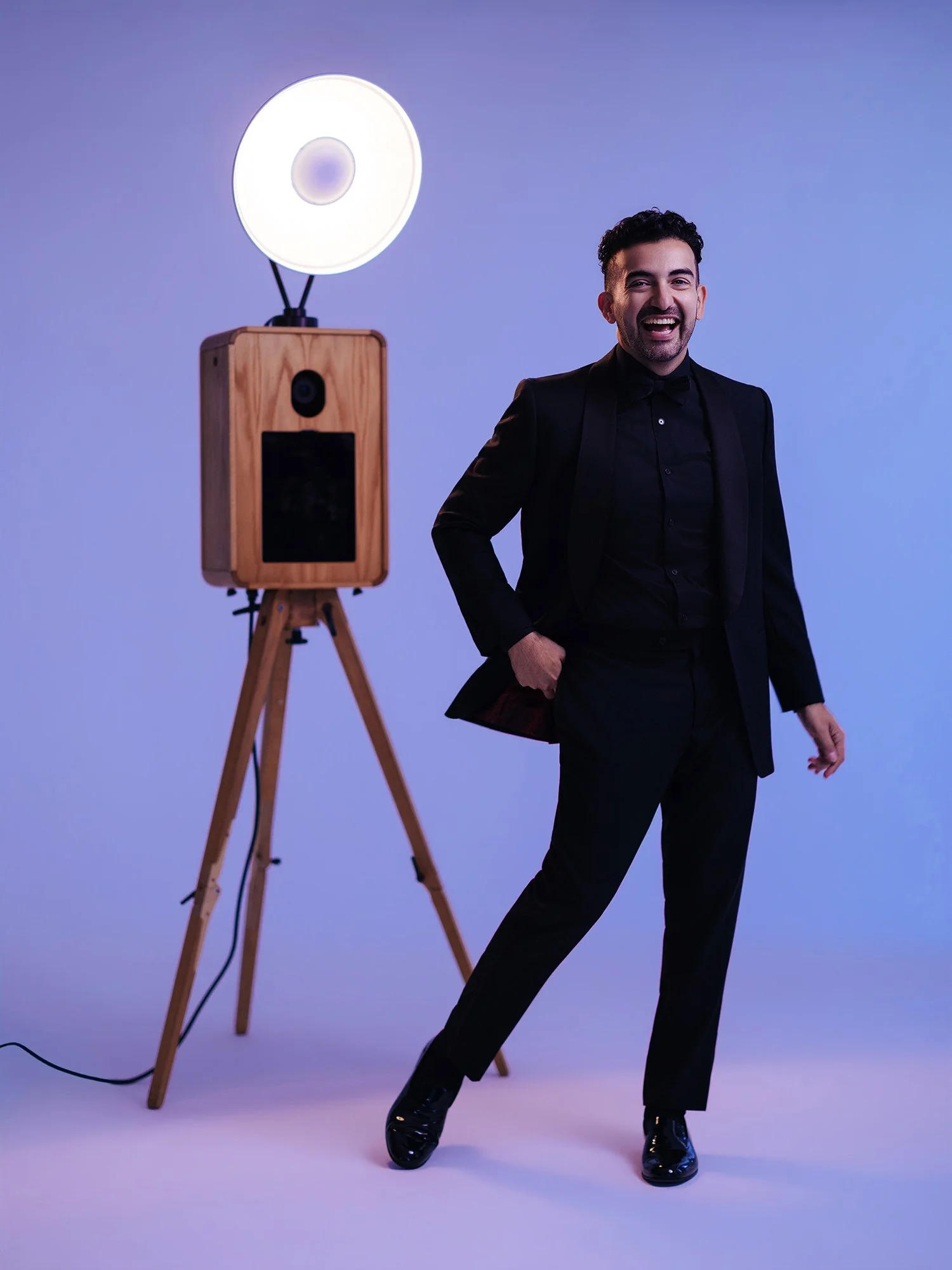 MBP Photo Booth founder setting up modern digital photo booth equipment at upscale corporate event venue