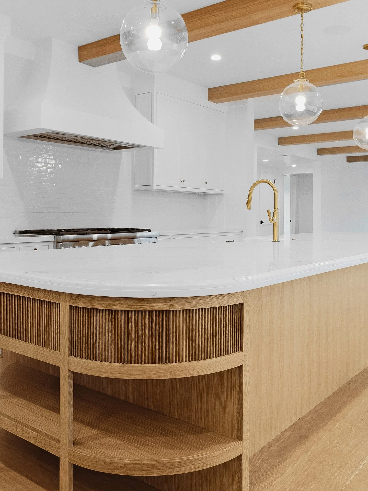 A kitchen that does more than cook &mdash; it makes a statement. ✨

The fluted wood island brings warmth and texture, while the custom-built hood creates a stunning focal point against crisp white cabinetry. Every detail was intentionally designed an