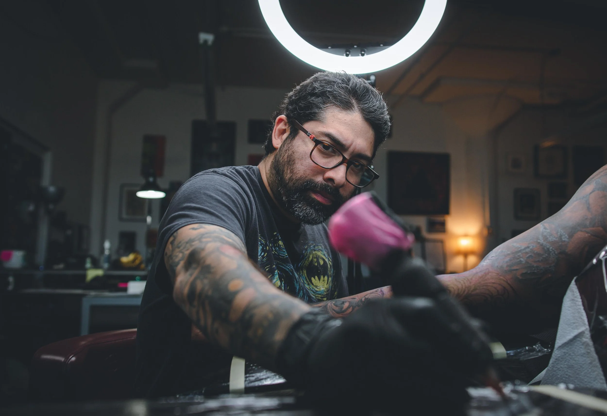 Black and gray tattoo artist Emmanuel Reyes tattooing a client in Stroudsburg, PA