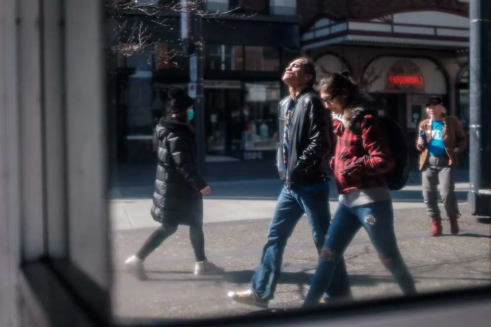 Daniel Mosquin Granville Street in Reflection, 2020 A dirty mirror provides a glimpse of a Granville Street scene on the weekend prior to widespread COVID-19 isolation. Even among the worries and tension, some still make the time for important
