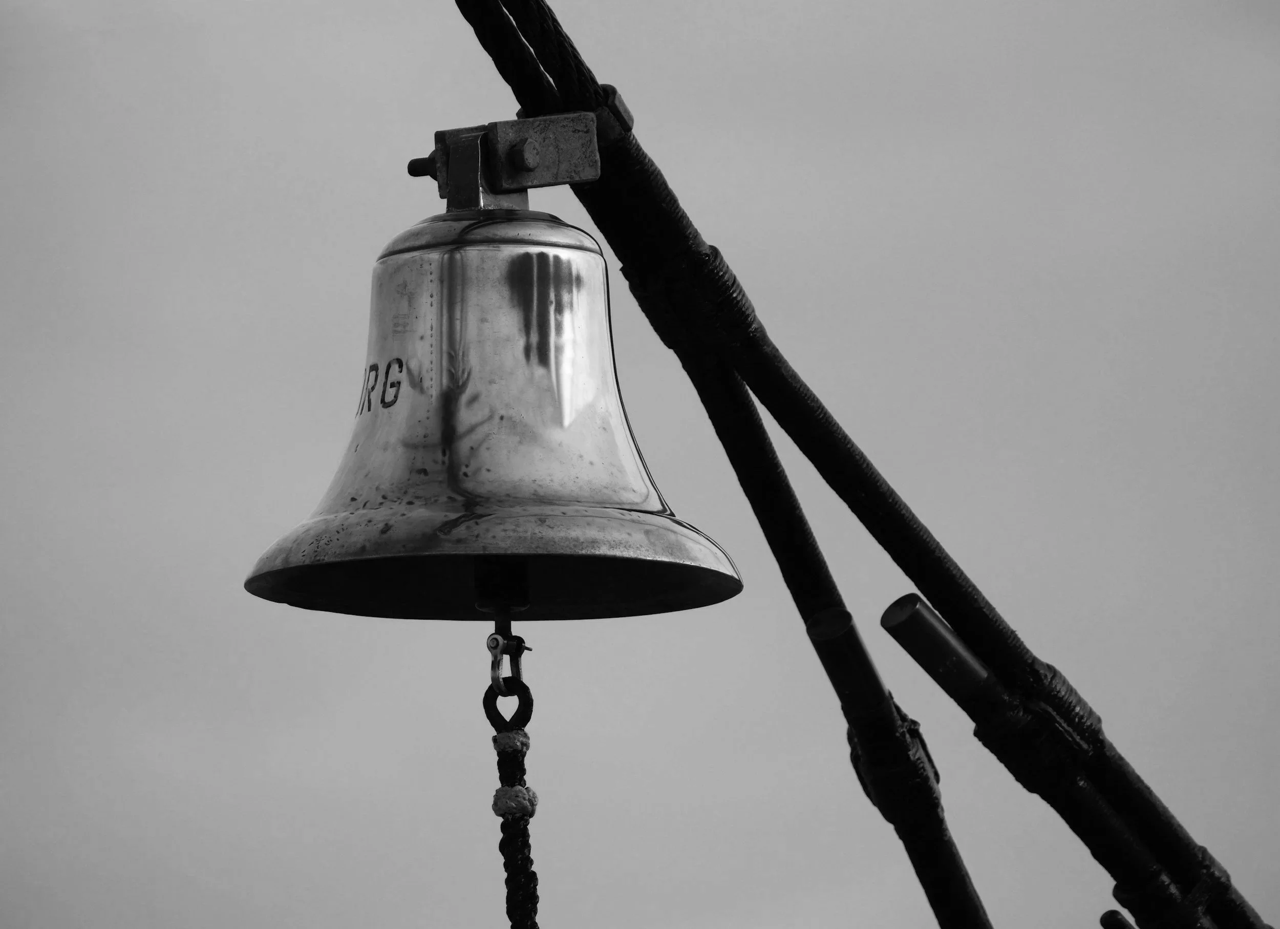 Black and white photo of a ships bell close up