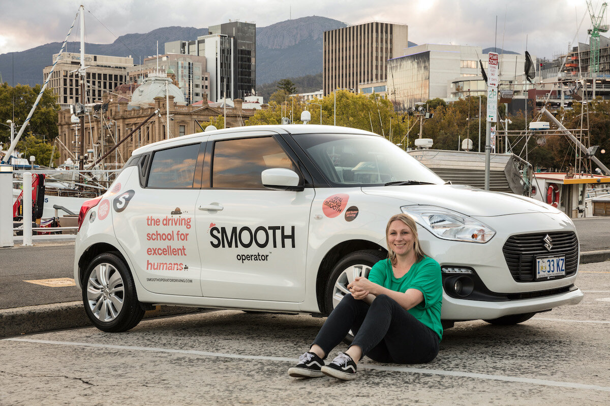 Kat sitting beside car.jpg