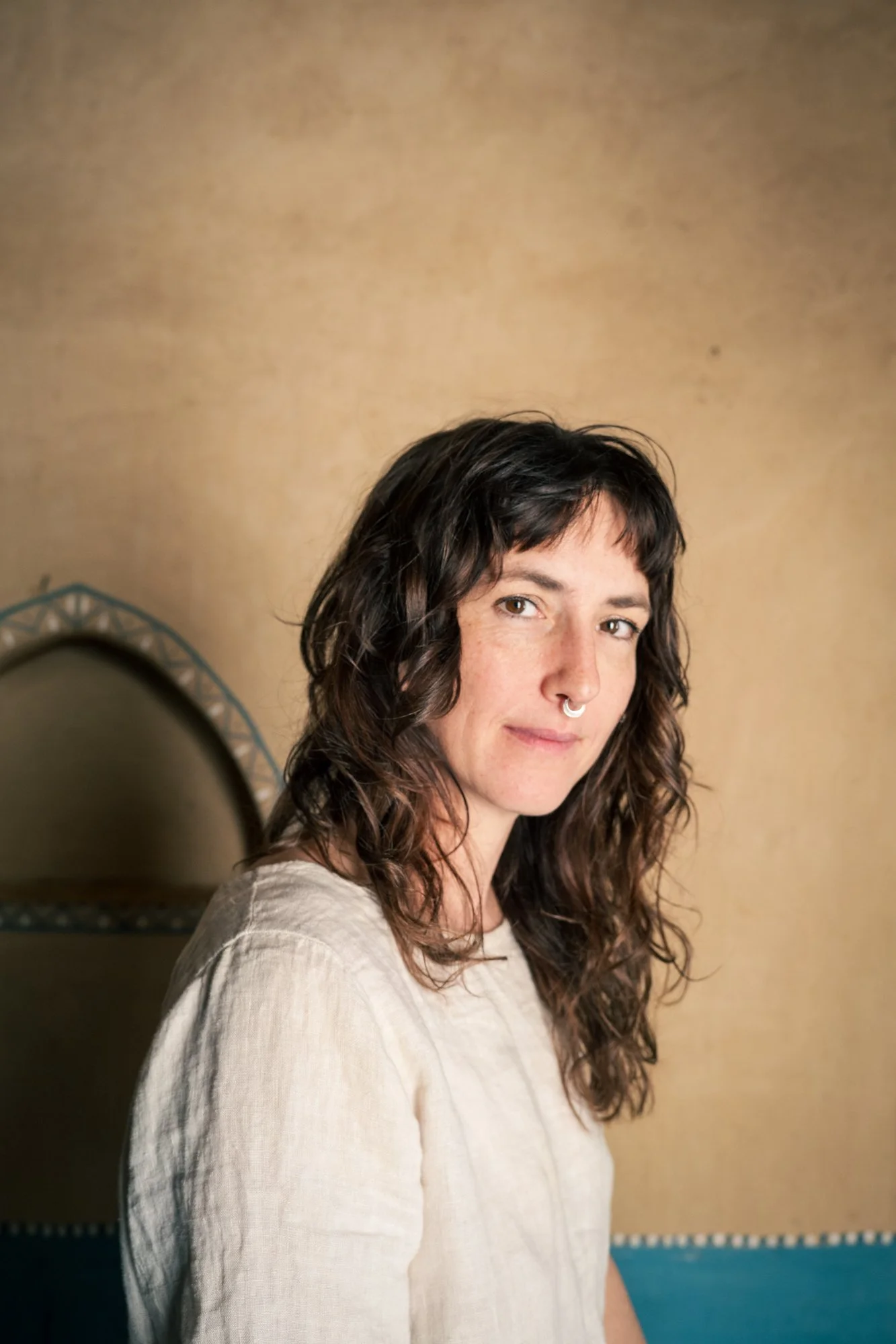 Therapist woman in creme top smiling