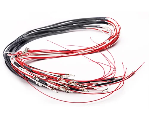 A collection of black and red electrical wires with connectors on the ends, arranged in a loose circular shape.