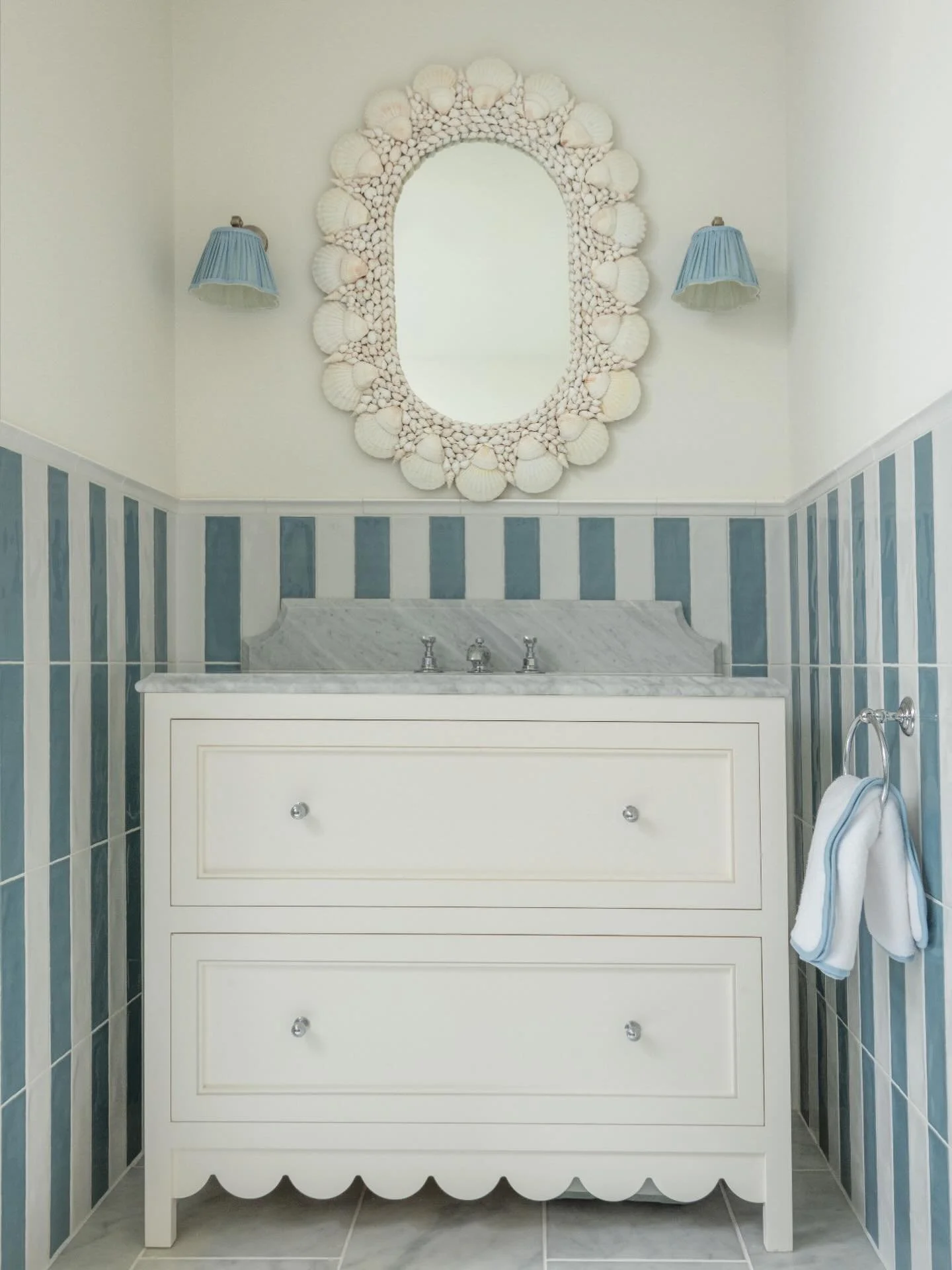 Proof that kids&rsquo; bathrooms can be just as chic as the rest of the house 💙✨
⠀⠀⠀⠀⠀⠀⠀⠀⠀
We turned this little space into a striped dream with bold blue-and-white stripes, a scalloped vanity detail, and the sweetest shell mirror stealing the show 