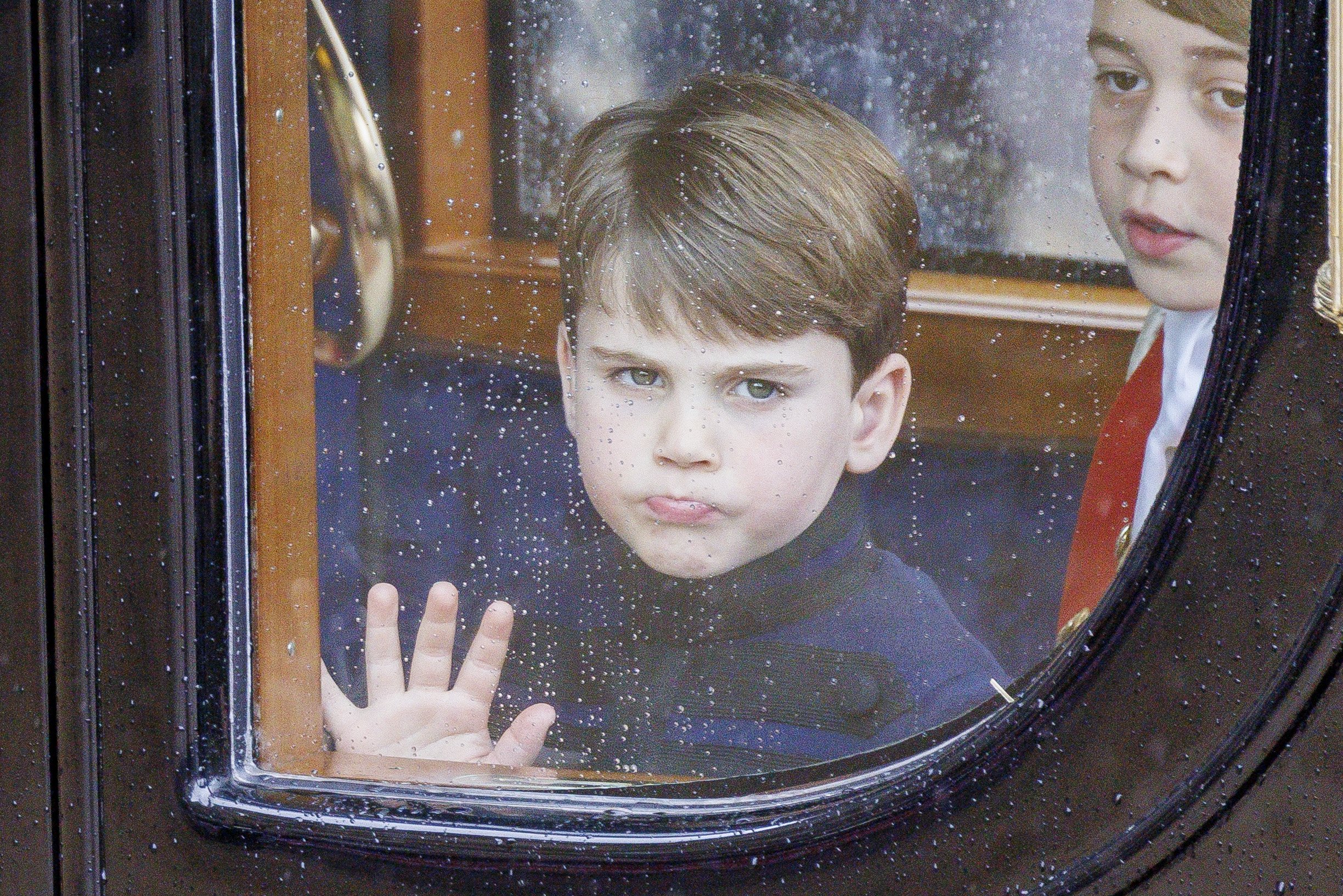  Prince Louis watches the crowd from his carriage during King Charles III’s Coronation procession - May 2023. 