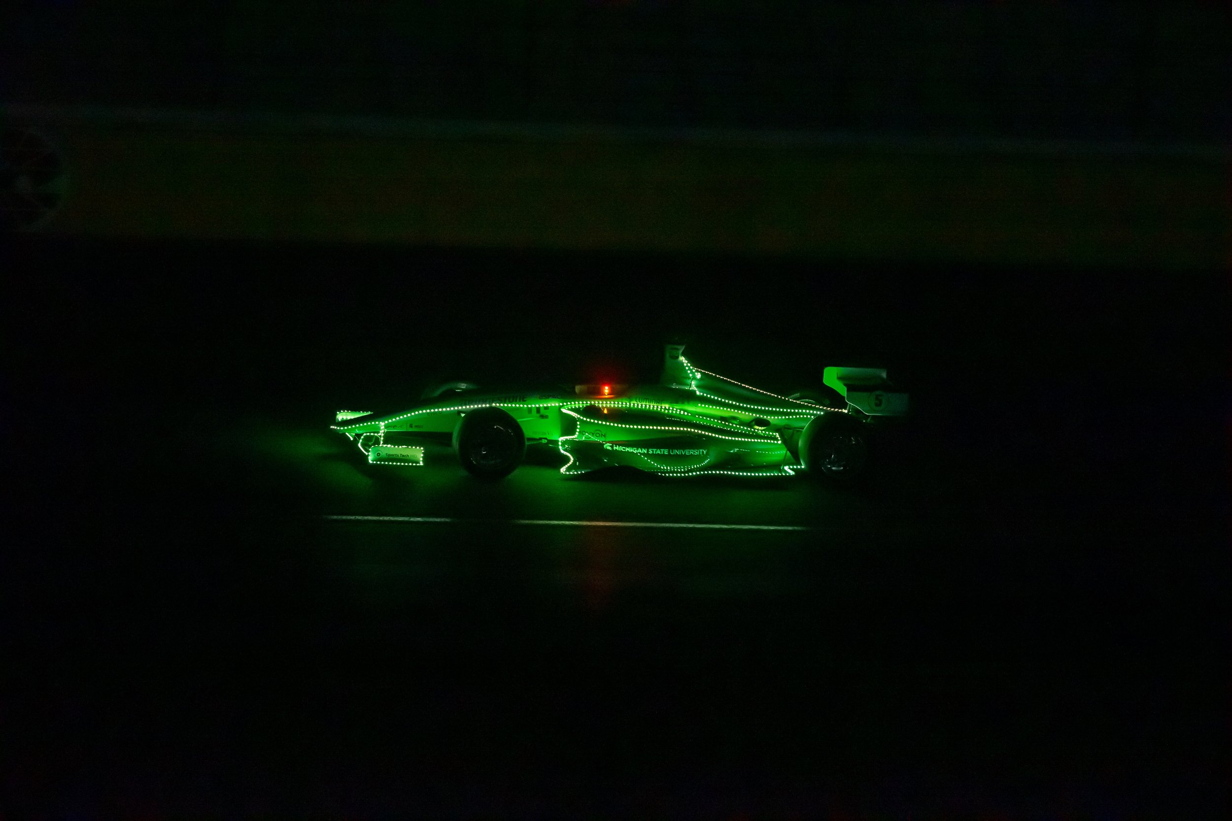   PoliMOVE-MSU races the IAC AV-24 in the dark at the Autonomous Challenge @ CES. Credit Indy Autonomous Challenge.  