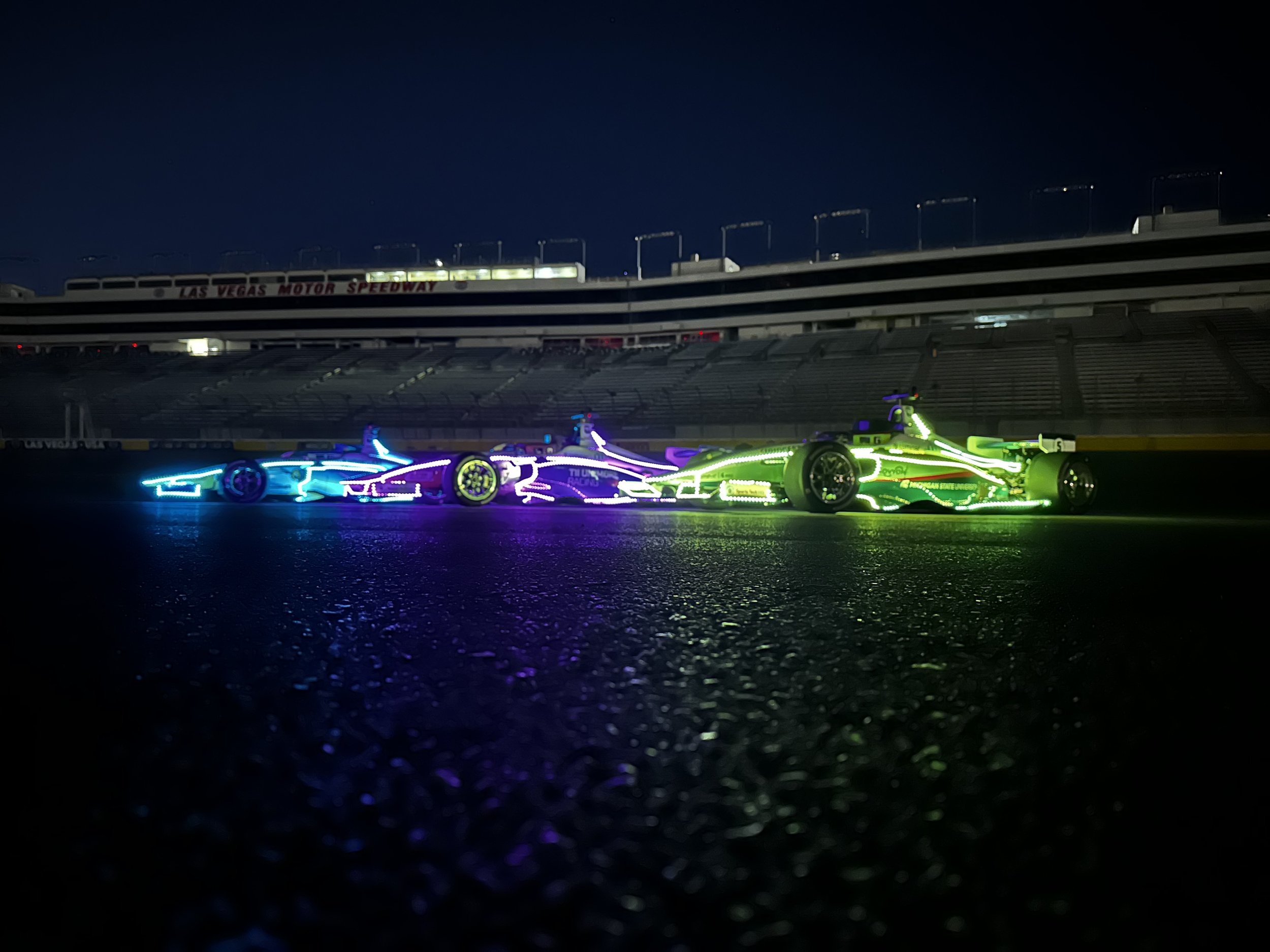   The new IAC AV-24 racecars lit up in the dark at the Las Vegas Motor Speedway for the Autonomous Challenge @ CES 2024. Credit Indy Autonomous Challenge.  