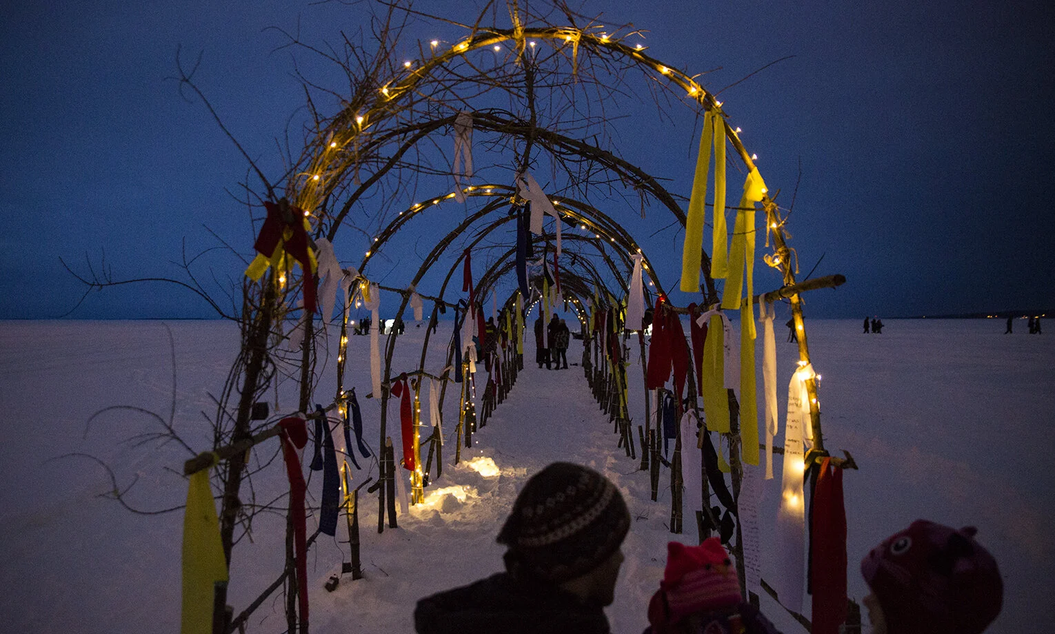 “Architectures of Transformation - Tamarack Archways” Serpent People Installation by Aanimitaagzi, Ice Follies, February 2018. Photo by Vanessa Tignanelli. This photo shows part of Aanmitaagzi's installation series and multi-year community engaged p…