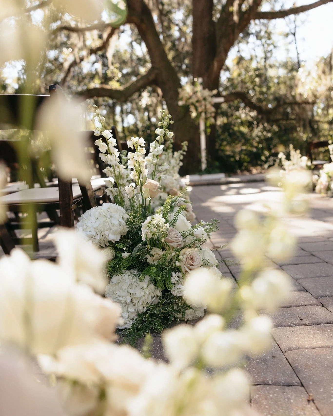 When stunning floral arrangements line the path of the most important walk you'll take! Two tips:

1️⃣ If you plan to have lush arrangements lining your aisle, let us know! We can set the chairs out a bit from our normal pattern to accommodate the ex