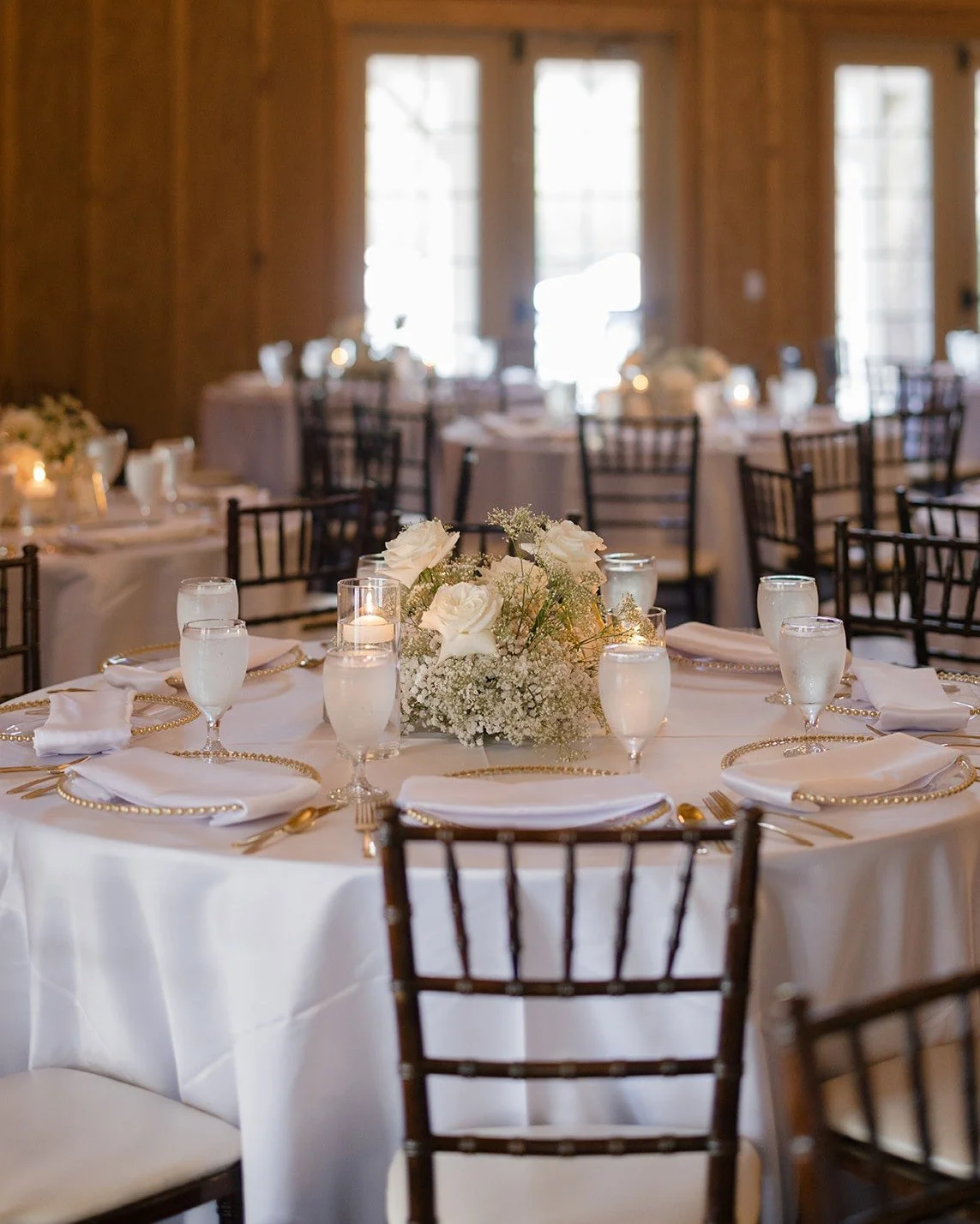 Layered whites, candlelight, and timeless details that never go out of style.

This reception design embraced the beauty of a monochromatic palette, proving that shades of white can feel anything but simple. From crisp linens and delicate florals to 