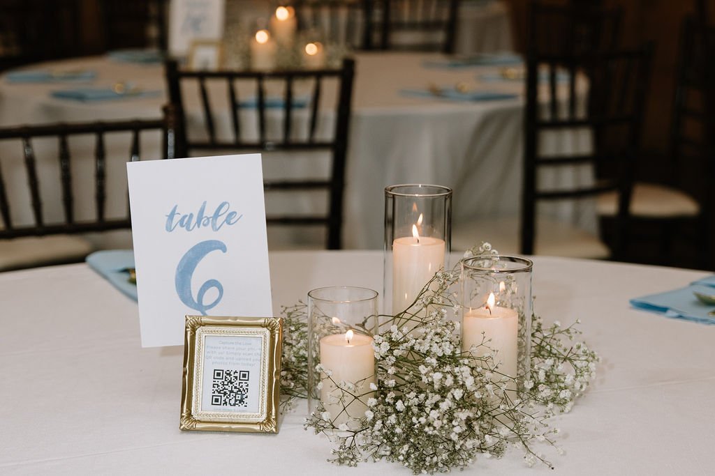 Simple details often make the strongest impression.

Soft baby&rsquo;s breath paired with the warm glow of pillar candles creates a centerpiece that feels understated, elegant, and effortlessly romantic. The flicker of candlelight, layered with delic
