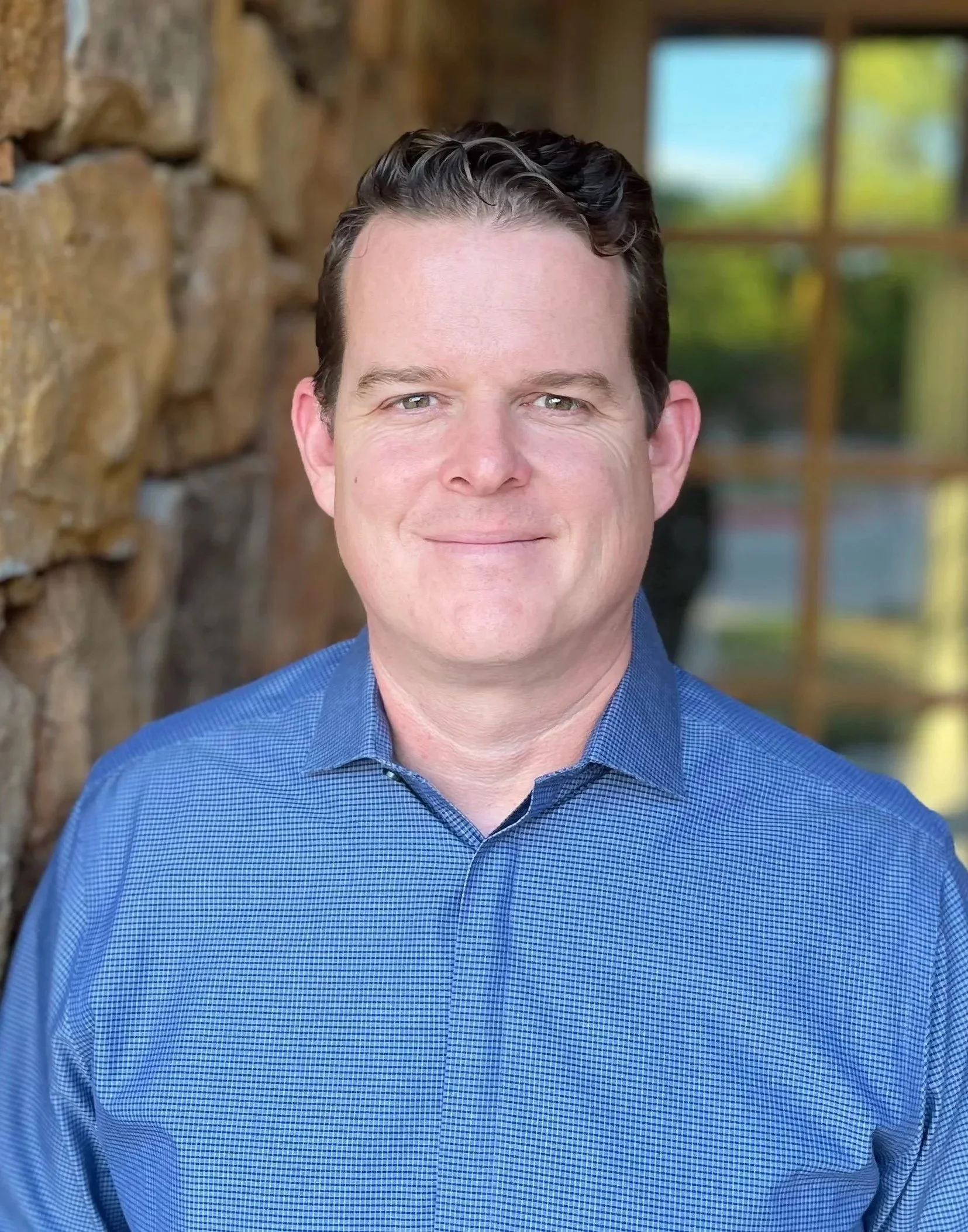 Zack Durham, couples & family therapist standing in front of office building of Harvest Counseling & Wellness in Argyle, TX. Zack specializes in anxiety/depression, TBIs, Stroke Recovery, Parenting & Family Issues, & Men's issues.