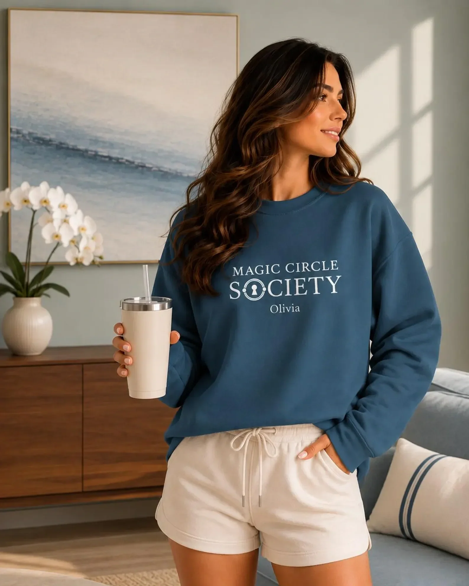 Woman wearing a personalized Casa Renegade Pilates sweatshirt with Magic Circle Society design