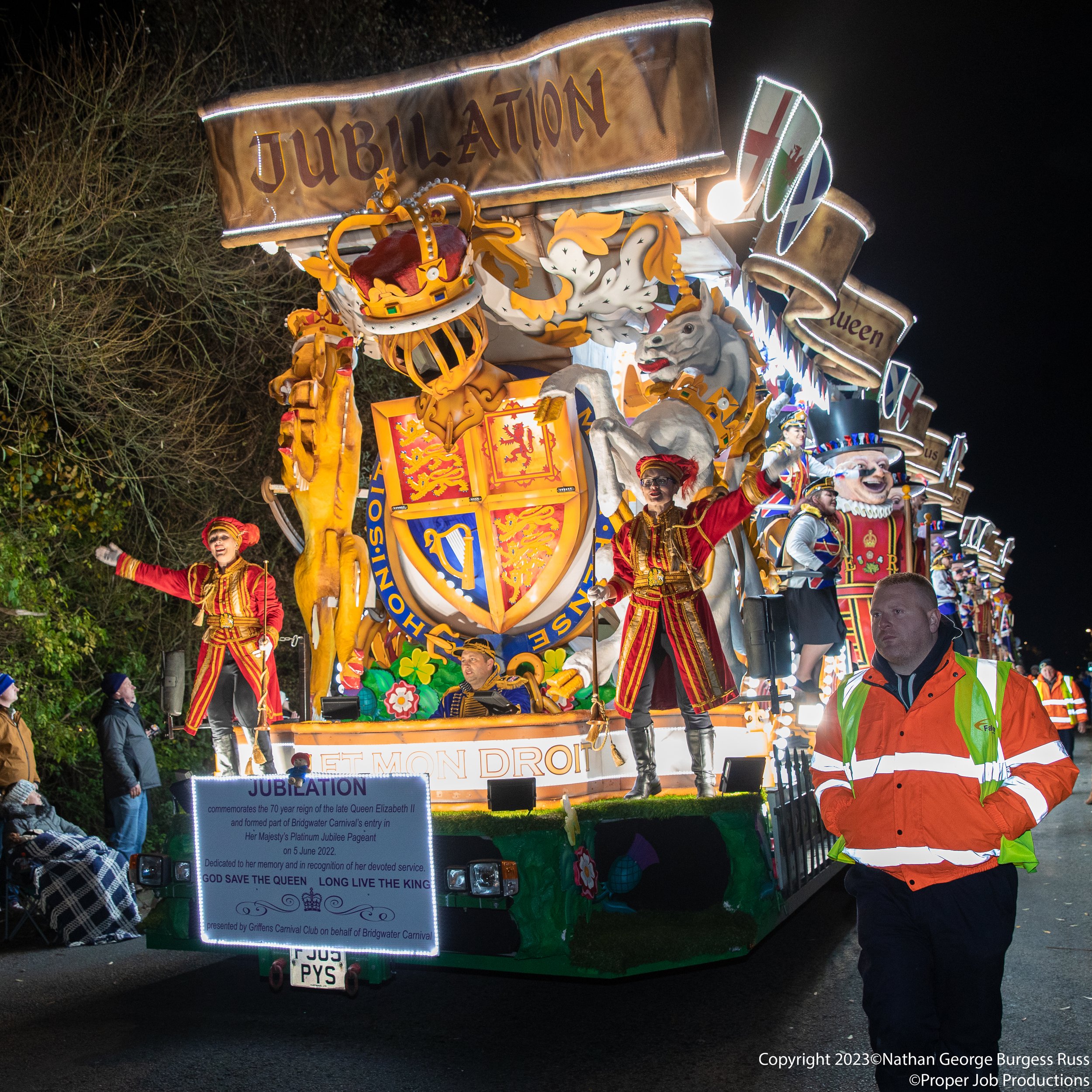 Jubilation by 17 of the Somerset Carnival Clubs at Glastonbury Carnival 2022.  

This feature Cart was created for Her Majesty Queen Elizabeth II Platinum Jubilee Pageant.

The Cart was built by 20 engineers, 10  carpenters, 15 painters, 10 electrici