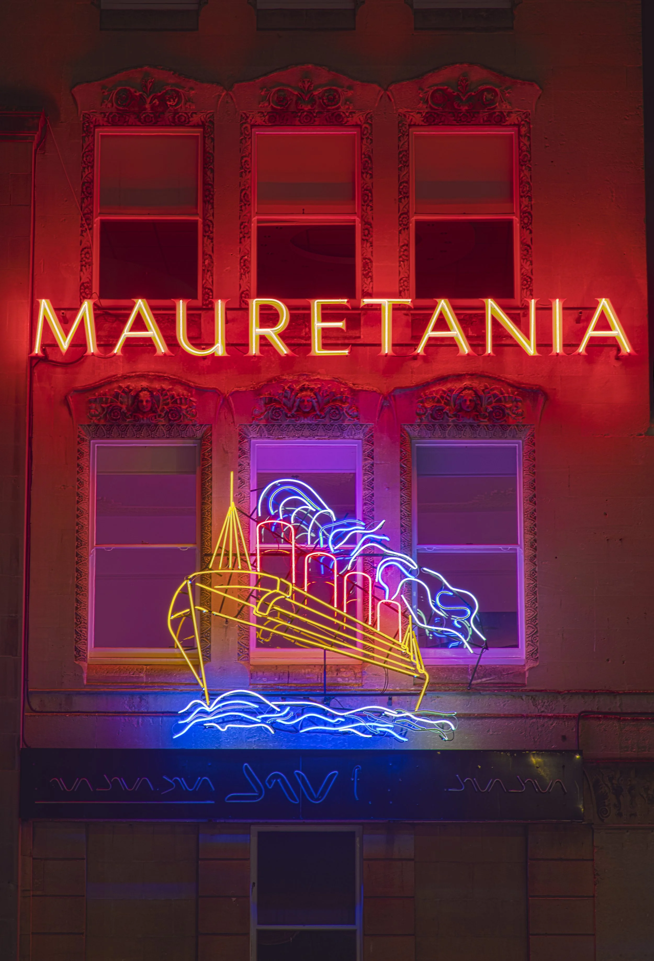 Nighttime Long Exposure of the Mauretania Neon Sign on the side of the Mauretania Public House, it is one of the oldest Neon Signs in the UK and the oldest in Bristol, having being installed in 1939 by Ronald Avery when the building was being extende